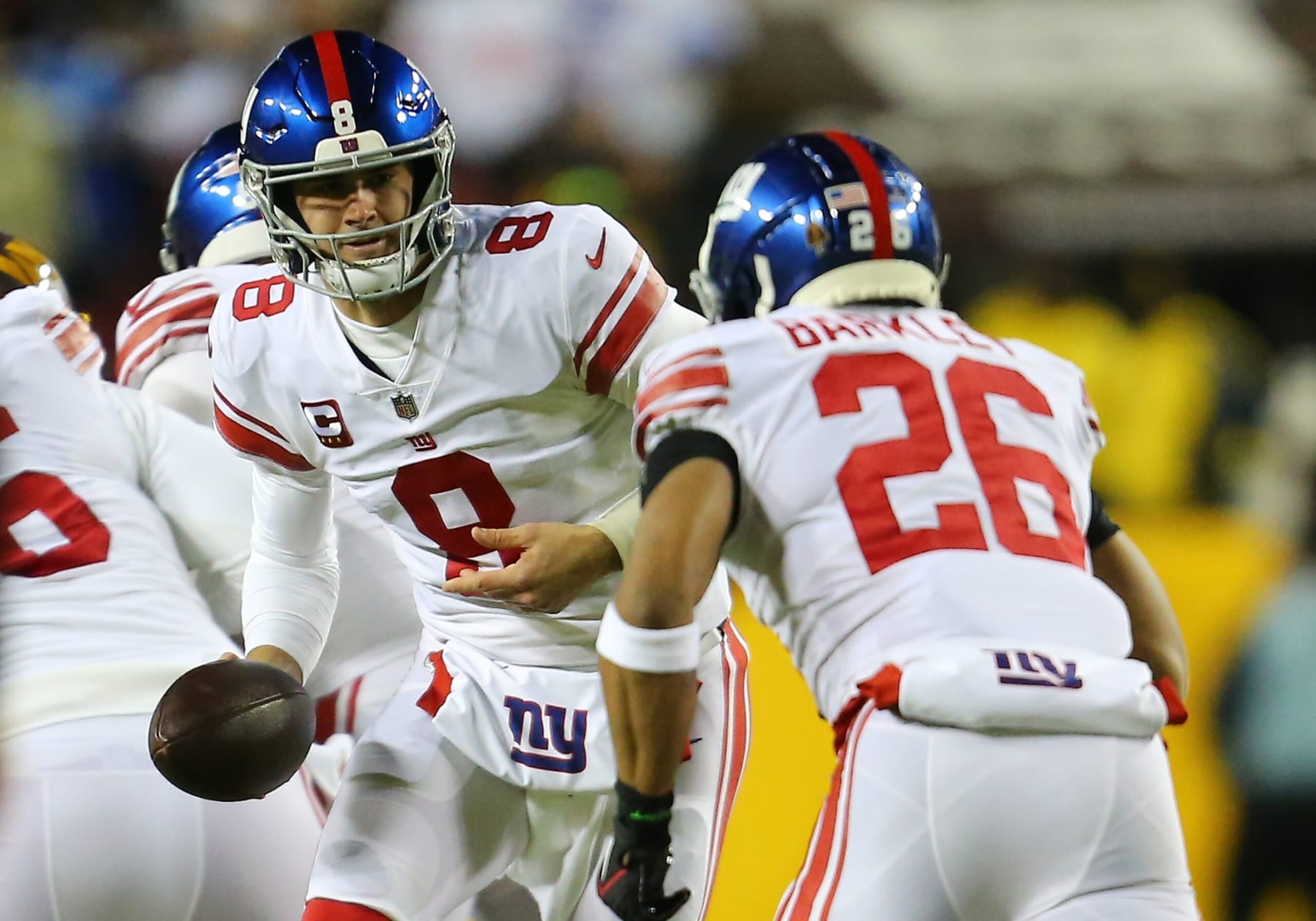 LANDOVER, MD - DECEMBER 18: New York Giants quarterback Daniel Jones (8) hands the ball to running back Saquon Barkley (26) during the New York Giants game versus the Washington Commanders on December 18, 2022, at FedEx Field in Landover, MD. (Photo by Lee Coleman/Icon Sportswire via Getty Images)