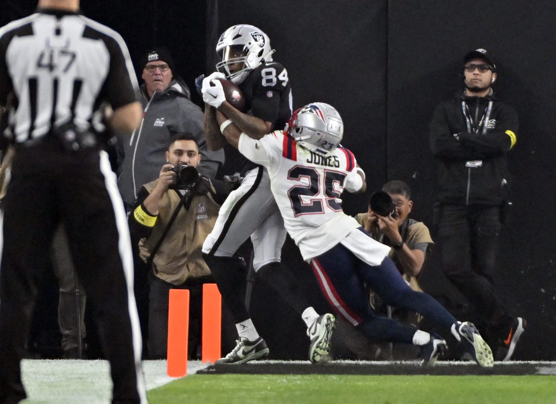 Las Vegas Raiders wide receiver Keelan Cole (84) catches a touchdown pass against New England Patriots cornerback Marcus Jones (25) during the second half of an NFL football game between the New England Patriots and Las Vegas Raiders, Sunday, Dec. 18, 2022, in Las Vegas. (AP Photo/David Becker)