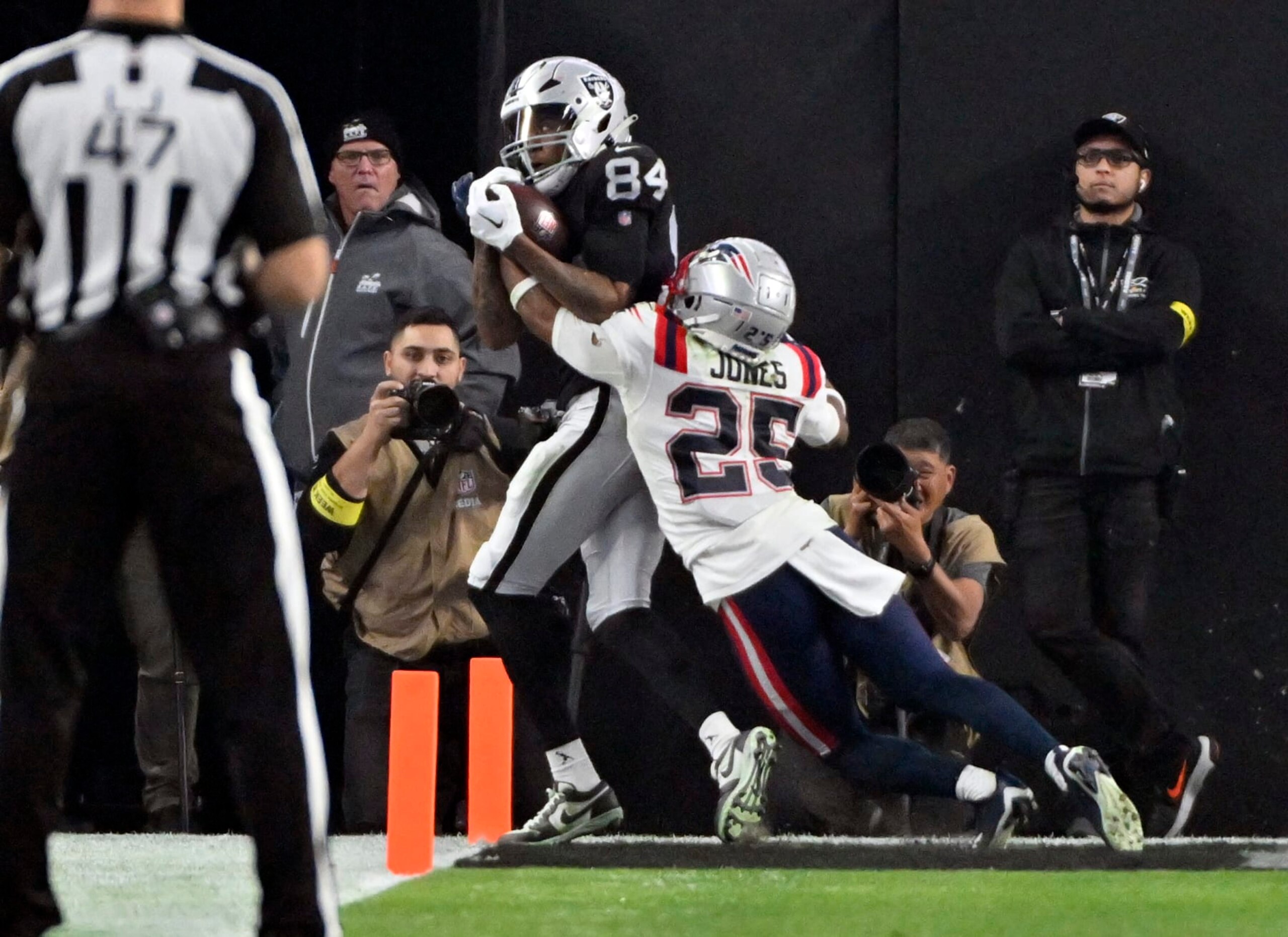 Las Vegas Raiders wide receiver Keelan Cole (84) catches a touchdown pass against New England Patriots cornerback Marcus Jones (25) during the second half of an NFL football game between the New England Patriots and Las Vegas Raiders, Sunday, Dec. 18, 2022, in Las Vegas. (AP Photo/David Becker)