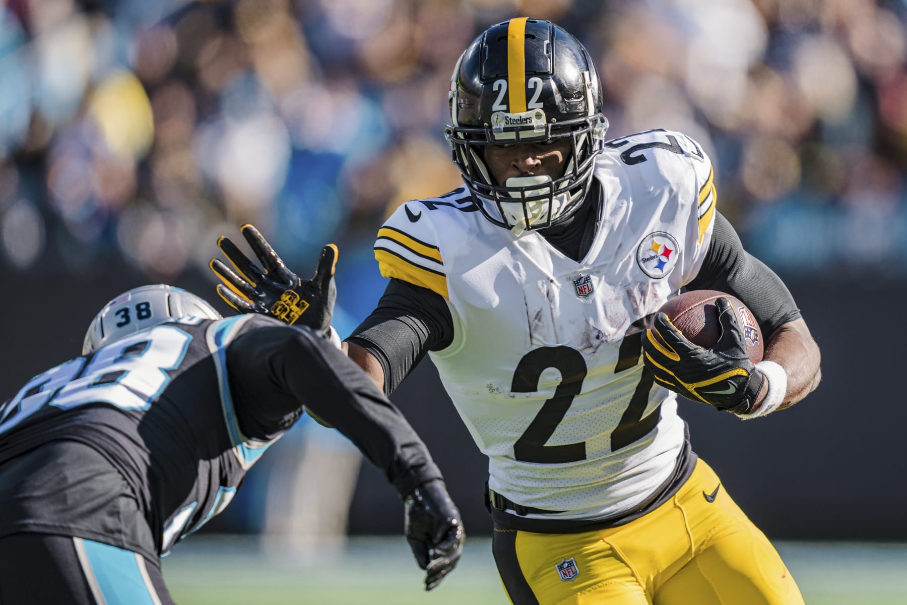Pittsburgh Steelers running back Najee Harris (22) tries to stiff arm Carolina Panthers cornerback Myles Hartsfield (38) during an NFL football game between the Carolina Panthers and the Pittsburgh Steelers on Sunday, Dec. 18, 2022, in Charlotte, N.C. (AP Photo/Jacob Kupferman)
