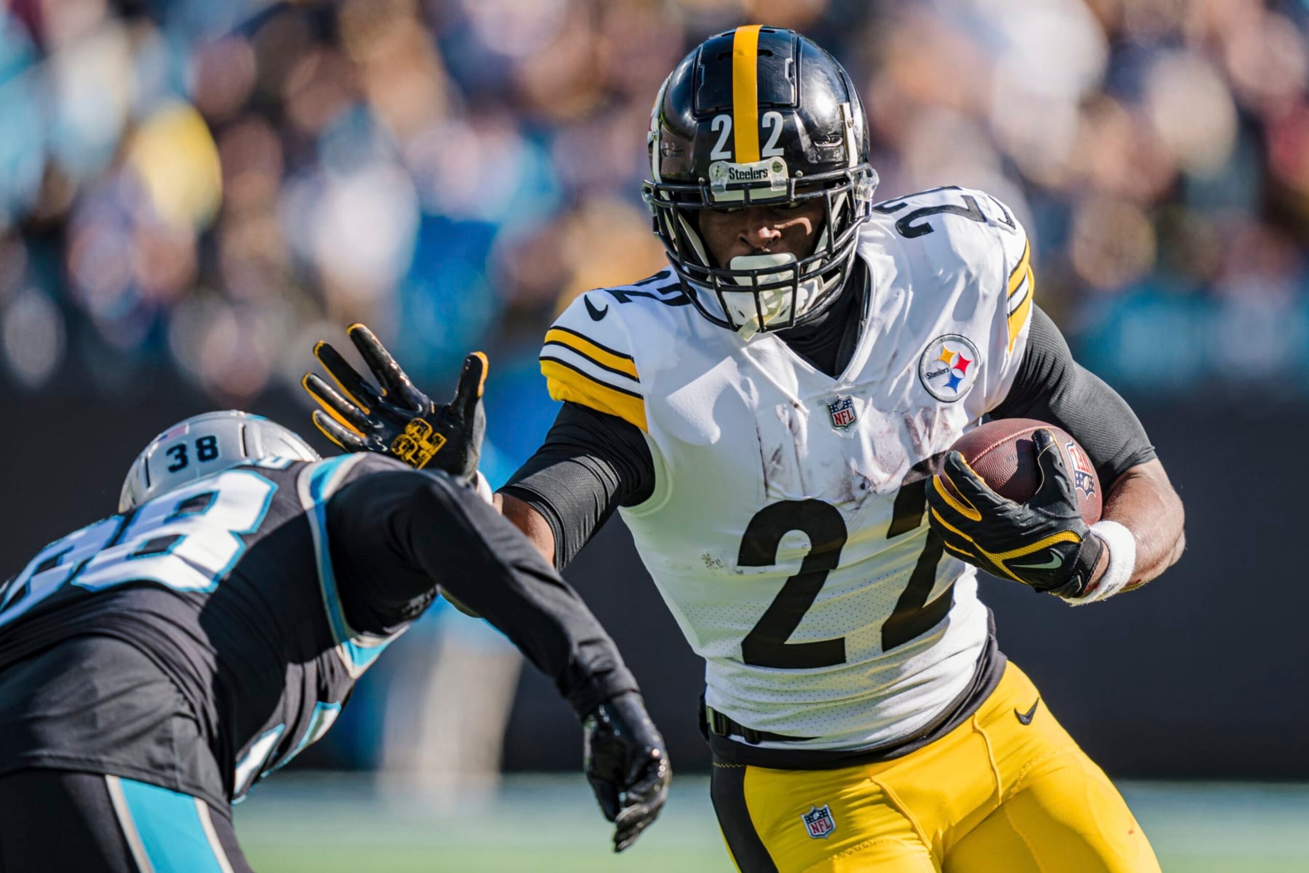 Pittsburgh Steelers running back Najee Harris (22) tries to stiff arm Carolina Panthers cornerback Myles Hartsfield (38) during an NFL football game between the Carolina Panthers and the Pittsburgh Steelers on Sunday, Dec. 18, 2022, in Charlotte, N.C. (AP Photo/Jacob Kupferman)