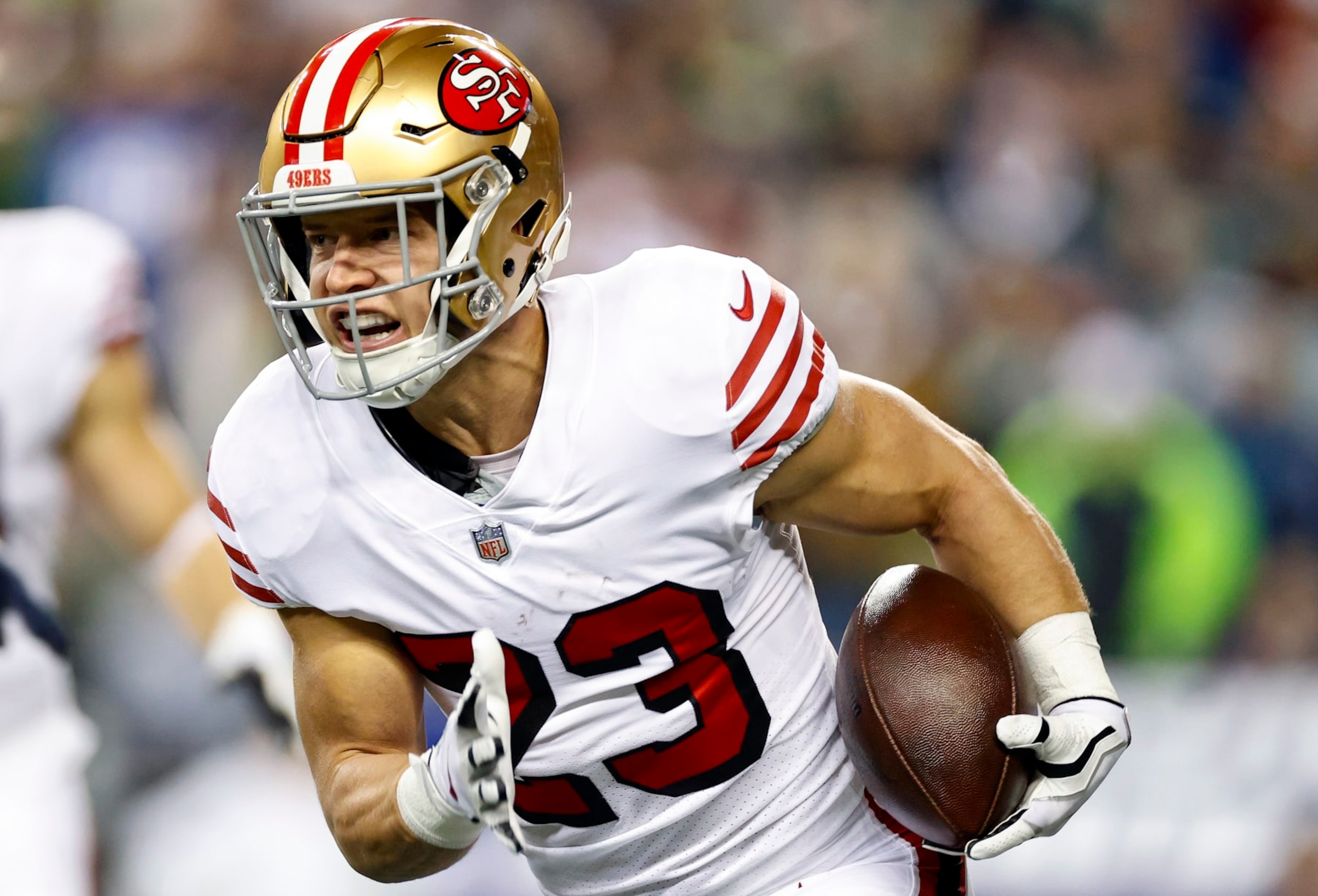 SEATTLE, WASHINGTON - DECEMBER 15: Christian McCaffrey #23 of the San Francisco 49ers carries the ball against the Seattle Seahawks during the first quarter of the game at Lumen Field on December 15, 2022 in Seattle, Washington. (Photo by Steph Chambers/Getty Images)