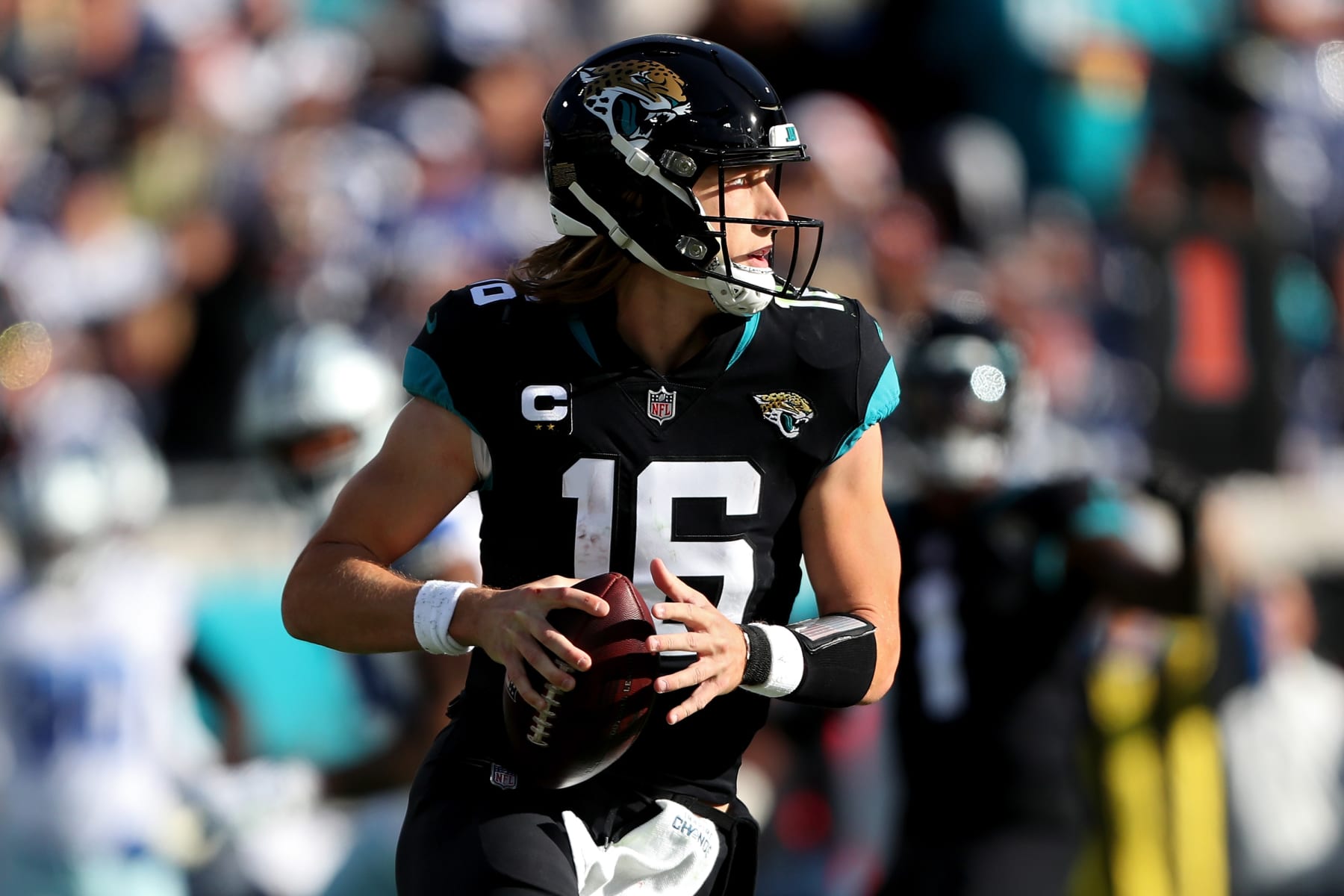 JACKSONVILLE, FLORIDA - DECEMBER 18: Trevor Lawrence #16 of the Jacksonville Jaguars looks to pass against the Dallas Cowboys during the second half at TIAA Bank Field on December 18, 2022 in Jacksonville, Florida. (Photo by Courtney Culbreath/Getty Images)