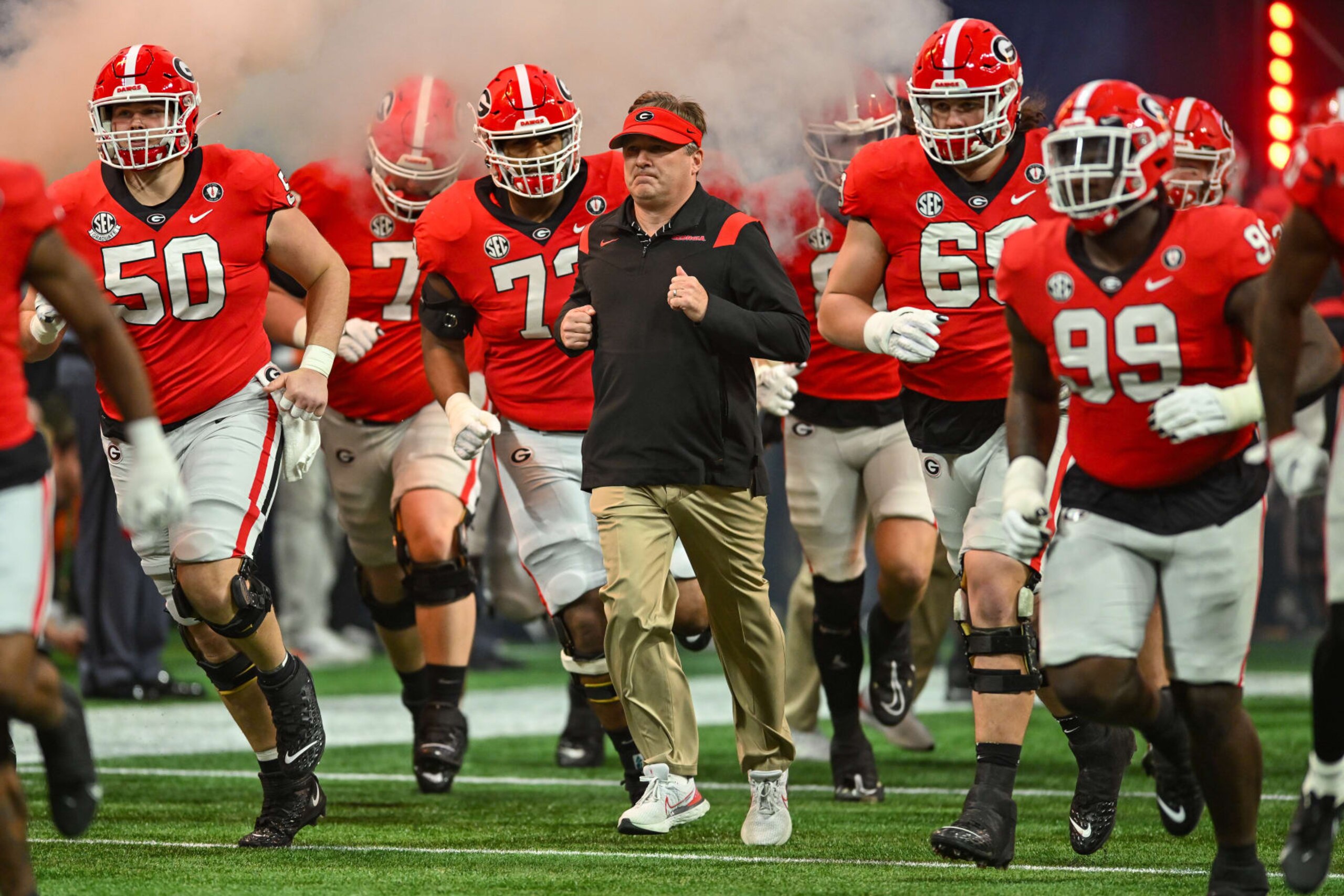 ATLANTA, GA  DECEMBER 03:  Georgia head coach Kirby Smart leads his team onto the field prior to the start of the SEC Championship football game between the LSU Tigers and the Georgia Bulldogs on December 3rd, 2022 at Mercedes-Benz Stadium in Atlanta, GA.  (Photo by Rich von Biberstein/Icon Sportswire via Getty Images)
