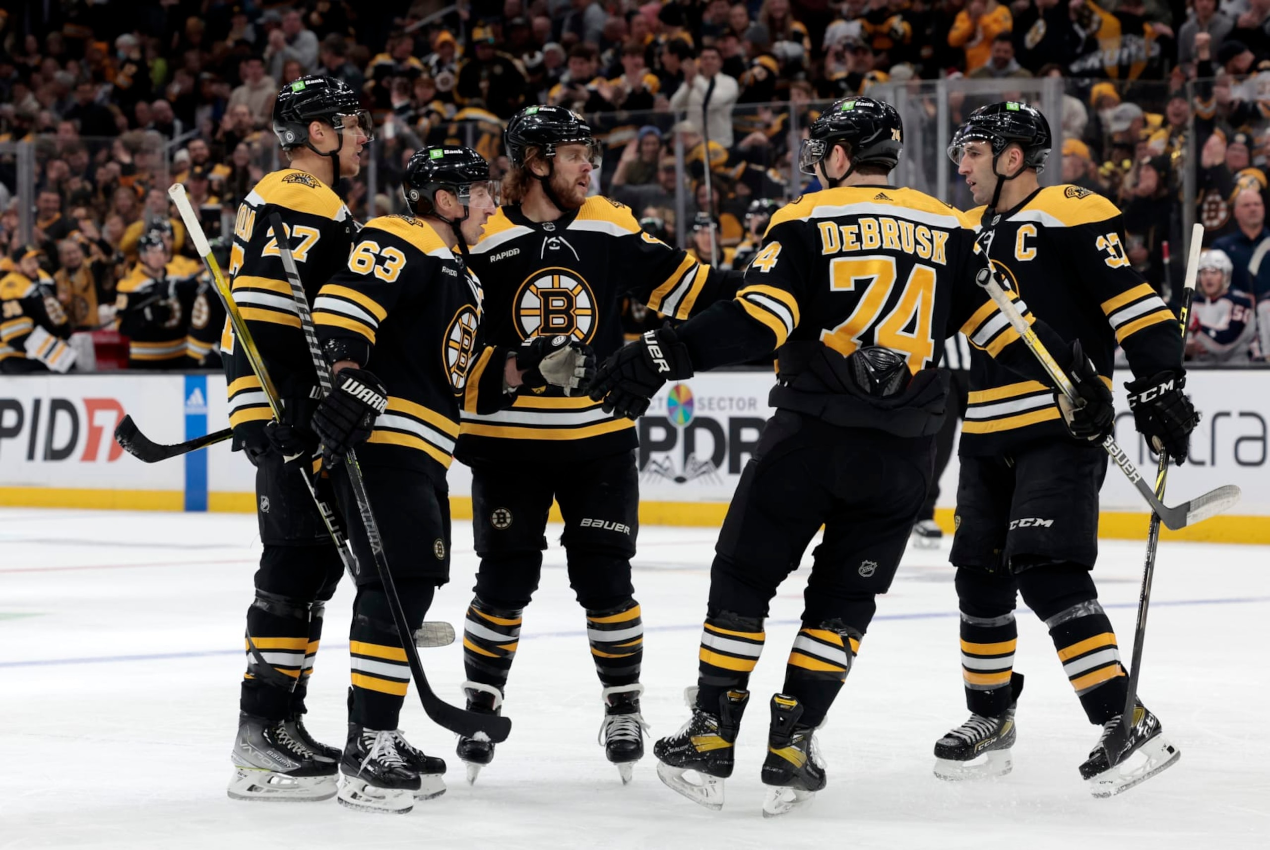 BOSTON, MA - DECEMBER 17: Boston congratulates Boston Bruins right wing David Pastrnak (88) on his opening goal during a game between the Boston Bruins and the Columbus Blue Jackets on December 17, 2022, at TD Garden in Boston, Massachusetts. (Photo by Fred Kfoury III/Icon Sportswire via Getty Images)
