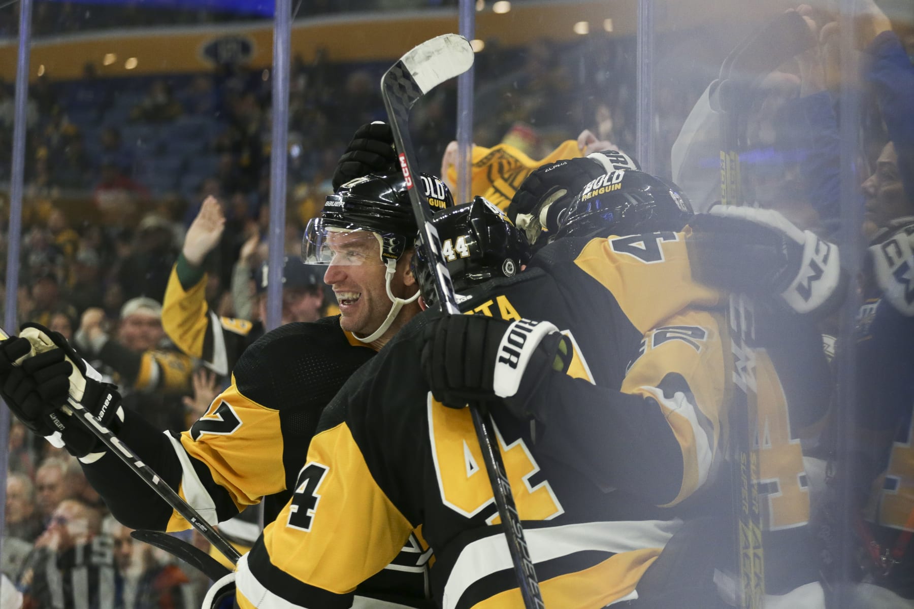 BUFFALO, NEW YORK - DECEMBER 09: Jeff Carter #77 of the Pittsburgh Penguins celebrates with teammates after a goal by Brock McGinn during the third period of an NHL hockey game against the Buffalo Sabres at KeyBank Center on December 09, 2022 in Buffalo, New York. (Photo by Joshua Bessex/Getty Images)