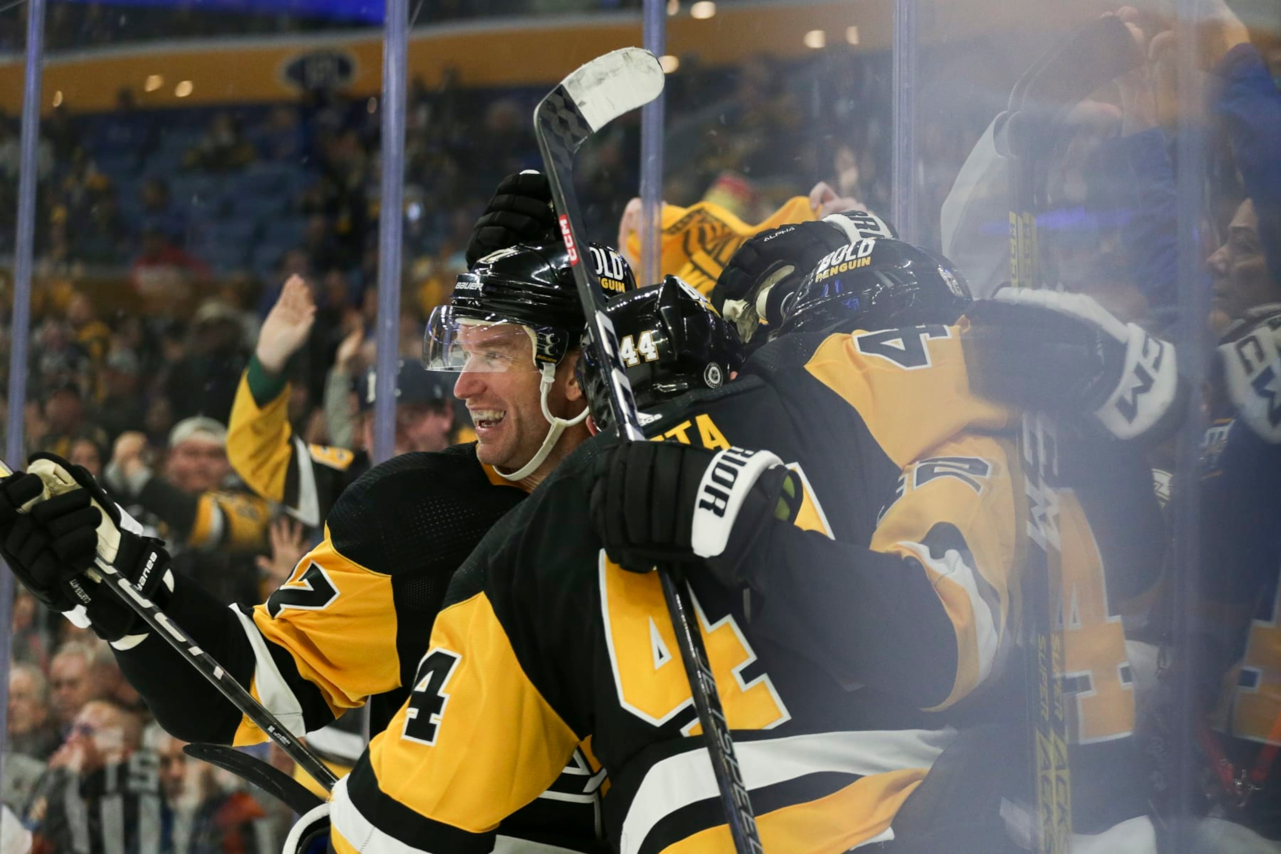 BUFFALO, NEW YORK - DECEMBER 09: Jeff Carter #77 of the Pittsburgh Penguins celebrates with teammates after a goal by Brock McGinn during the third period of an NHL hockey game against the Buffalo Sabres at KeyBank Center on December 09, 2022 in Buffalo, New York. (Photo by Joshua Bessex/Getty Images)