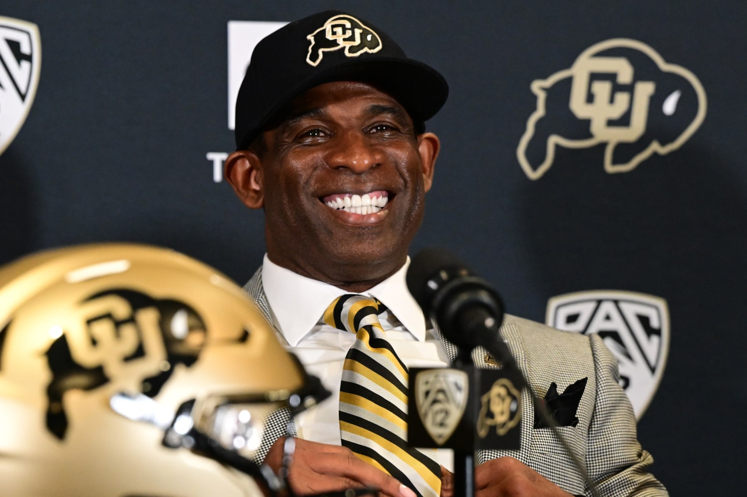 BOULDER, CO - DECEMBER 4: Deion Sanders, CUs new head football coach, takes questions in the Arrow Touchdown Club during a press conference on December 4, 2022 in Boulder, Colorado. CU held an introductory press conference to announce the hiring of Deion Coach Prime Sanders as the schools new head football coach. Chancellor Phil DiStefano and athletic director Rick George accompanied Sanders into a packed room in the Arrow Touchdown Club inside the Dal Ward Athletic Center. Sanders becomes the 28th head coach in Buffalo football history. Sanders, who known as Prime Time during his Hall of Fame playing career has since transitioned into Coach Prime as a head football coach. Sanders, 55, joins the CU program from Jackson State University where in three seasons the Tigers compiled a 27-5 record and won back-to-back Southwestern Athletic Conference championships. (Photo by Helen H. Richardson/MediaNews Group/The Denver Post via Getty Images) BOULDER, CO - DECEMBER 4: Deion Sanders, CUs new head football coach, takes questions in the Arrow Touchdown Club during a press conference on December 4, 2022 in Boulder, Colorado. CU held an introductory press conference to announce the hiring of Deion Coach Prime Sanders as the schools new head football coach. Chancellor Phil DiStefano and athletic director Rick George accompanied Sanders into a packed room in the Arrow Touchdown Club inside the Dal Ward Athletic Center. Sanders becomes the 28th head coach in Buffalo football history. Sanders, who known as Prime Time during his Hall of Fame playing career has since transitioned into Coach Prime as a head football coach. Sanders, 55, joins the CU program from Jackson State University where in three seasons the Tigers compiled a 27-5 record and won back-to-back Southwestern Athletic Conference championships. (Photo by Helen H. Richardson/MediaNews Group/The Denver Post via Getty Images)