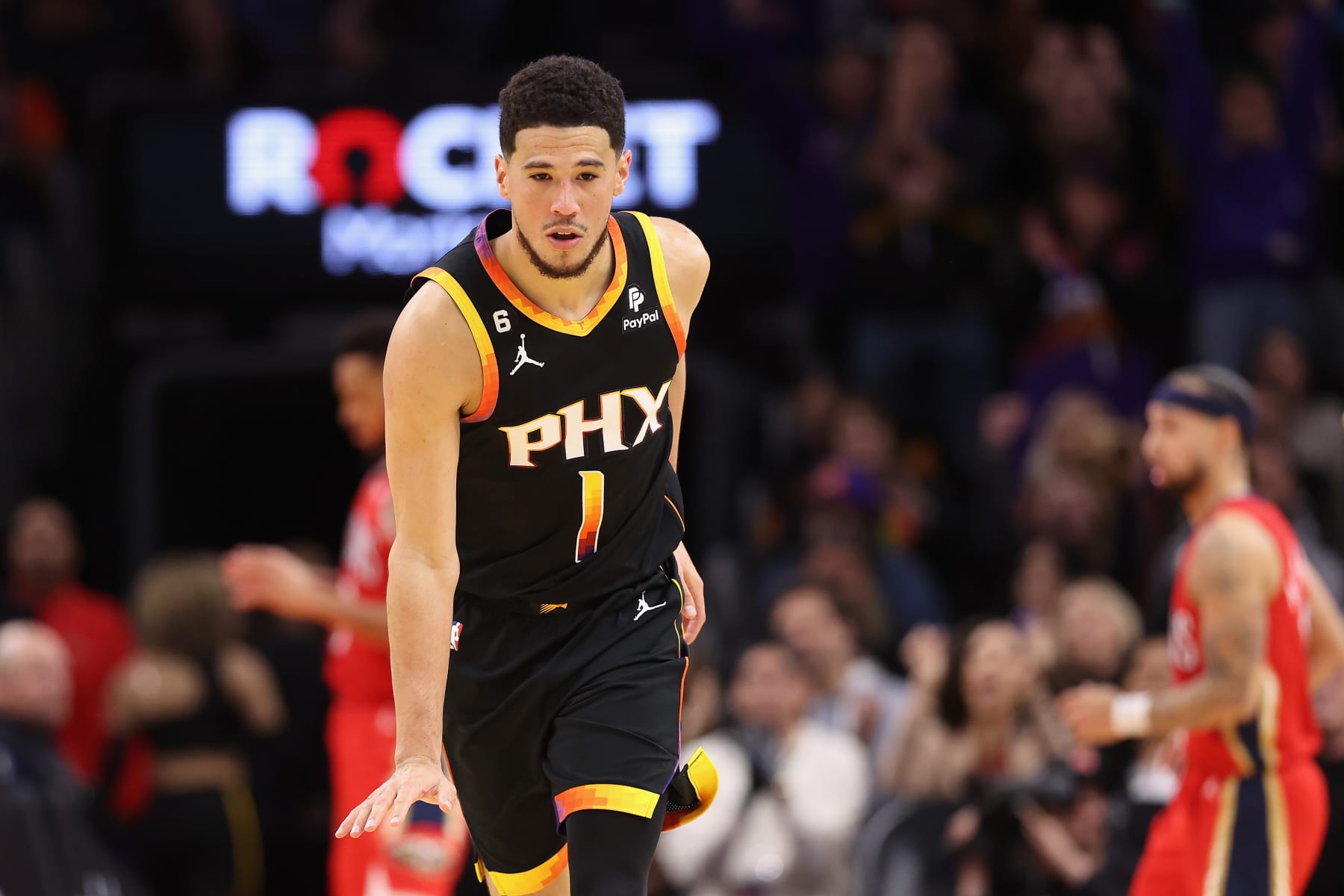 PHOENIX, ARIZONA - DECEMBER 17: Devin Booker #1 of the Phoenix Suns reacts after scoring against the New Orleans Pelicans during the second half of the NBA game at Footprint Center on December 17, 2022 in Phoenix, Arizona. The Suns defeated the Pelicans 118-114.  NOTE TO USER: User expressly acknowledges and agrees that, by downloading and or using this photograph, User is consenting to the terms and conditions of the Getty Images License Agreement. (Photo by Christian Petersen/Getty Images)