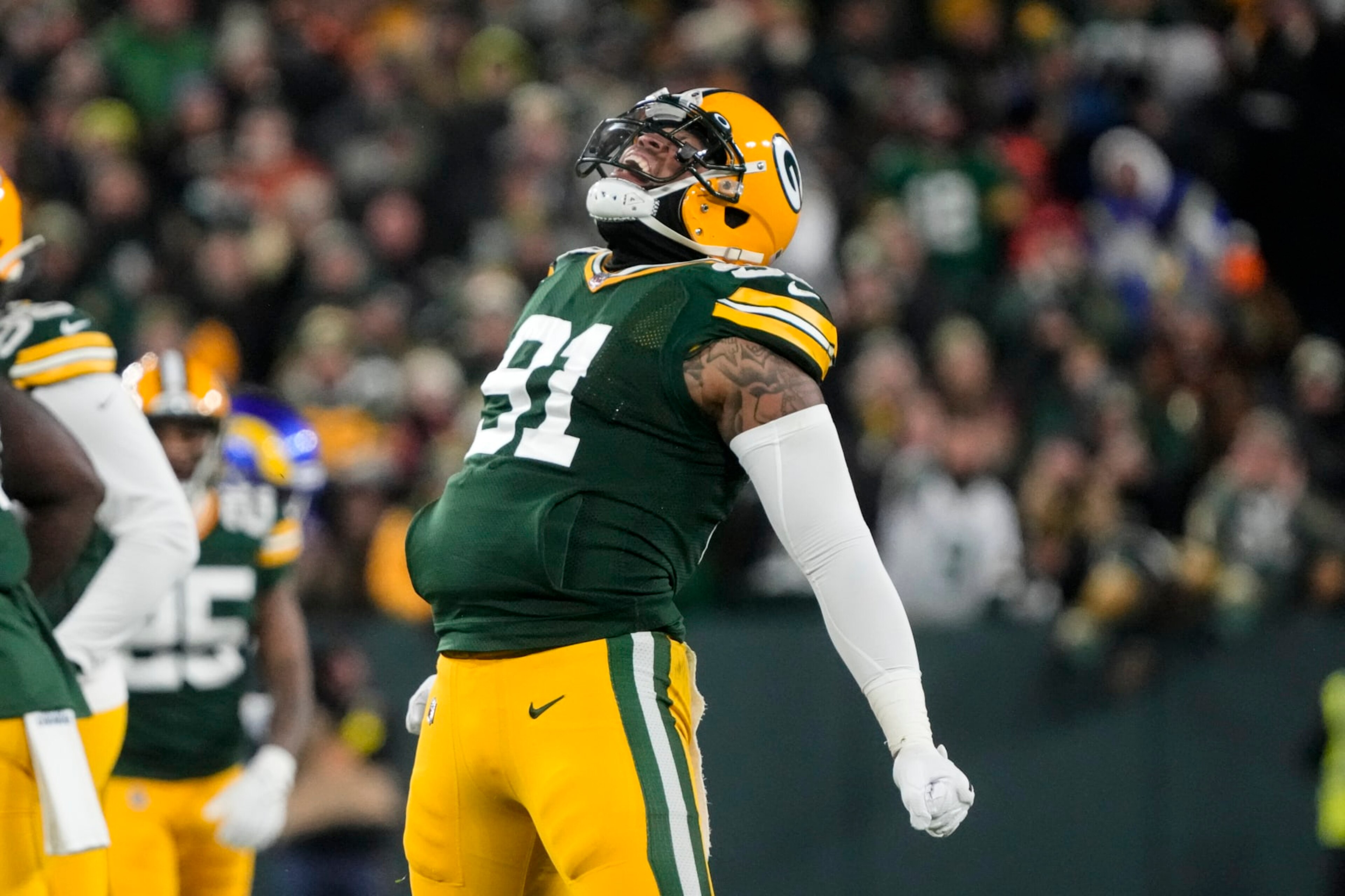 Green Bay Packers linebacker Preston Smith (91) celebrates a sack in the first half of an NFL football game against the Los angles Rams in Green Bay, Wis. Monday, Dec. 19, 2022. (AP Photo/Morry Gash)