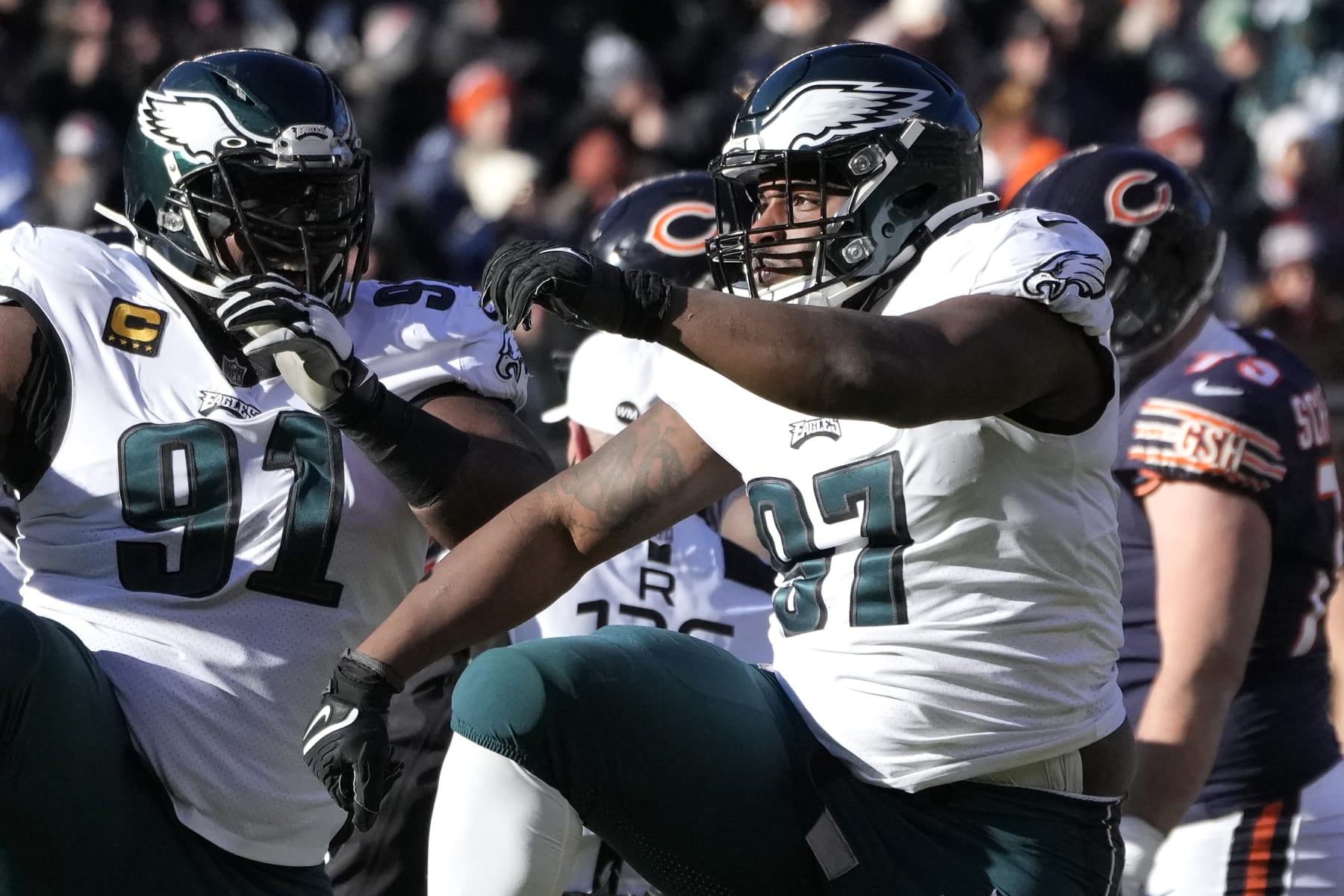 Philadelphia Eagles' Fletcher Cox, left, and Javon Hargrave celebrate Hargrave's sack of Chicago Bears quarterback Justin Fields during an NFL football game Sunday, Dec. 18, 2022, in Chicago. (AP Photo/Charles Rex Arbogast)