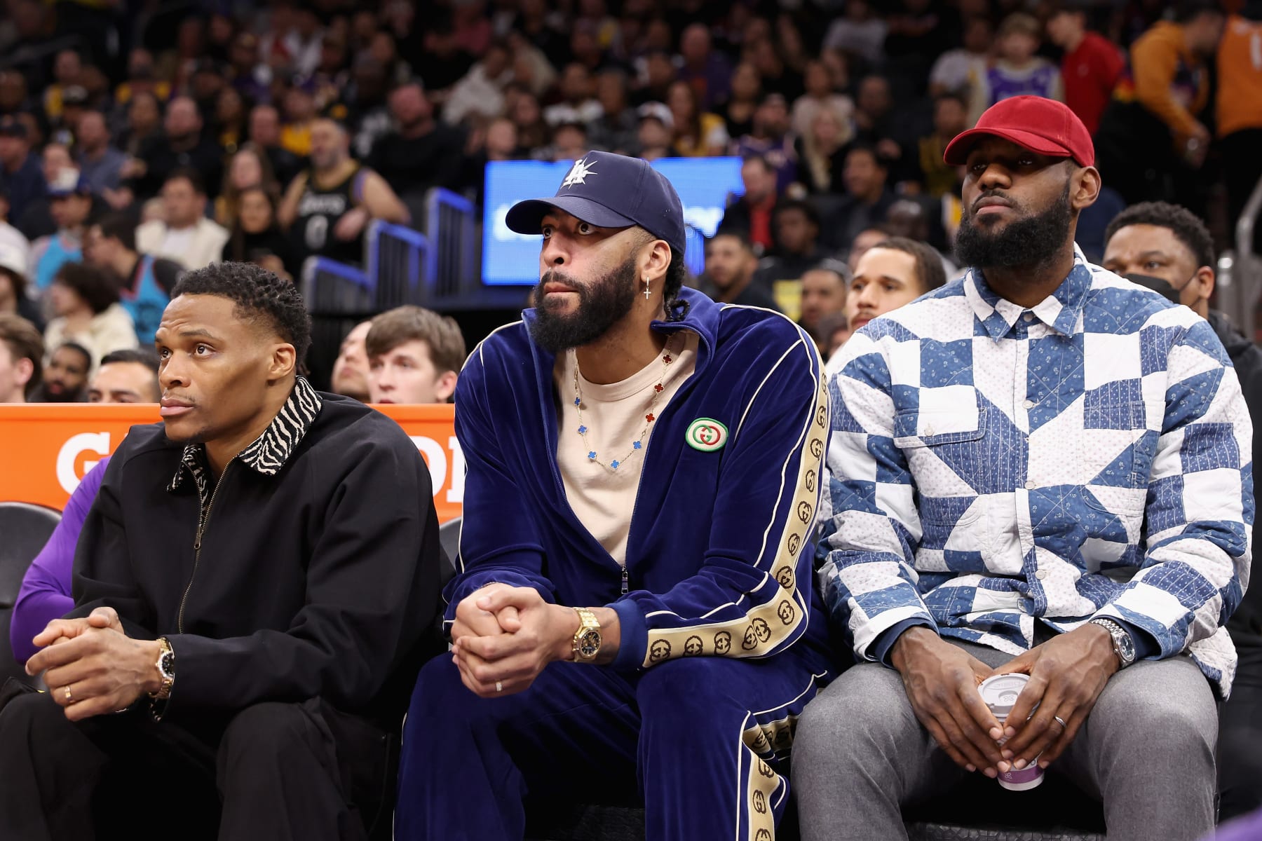 PHOENIX, ARIZONA - DECEMBER 19: (L-R) Russell Westbrook #0, Anthony Davis #3 and LeBron James #6 of the Los Angeles Lakers watch from the bench during the first half of the NBA game against the Phoenix Suns at Footprint Center on December 19, 2022 in Phoenix, Arizona. NOTE TO USER: User expressly acknowledges and agrees that, by downloading and or using this photograph, User is consenting to the terms and conditions of the Getty Images License Agreement. (Photo by Christian Petersen/Getty Images)