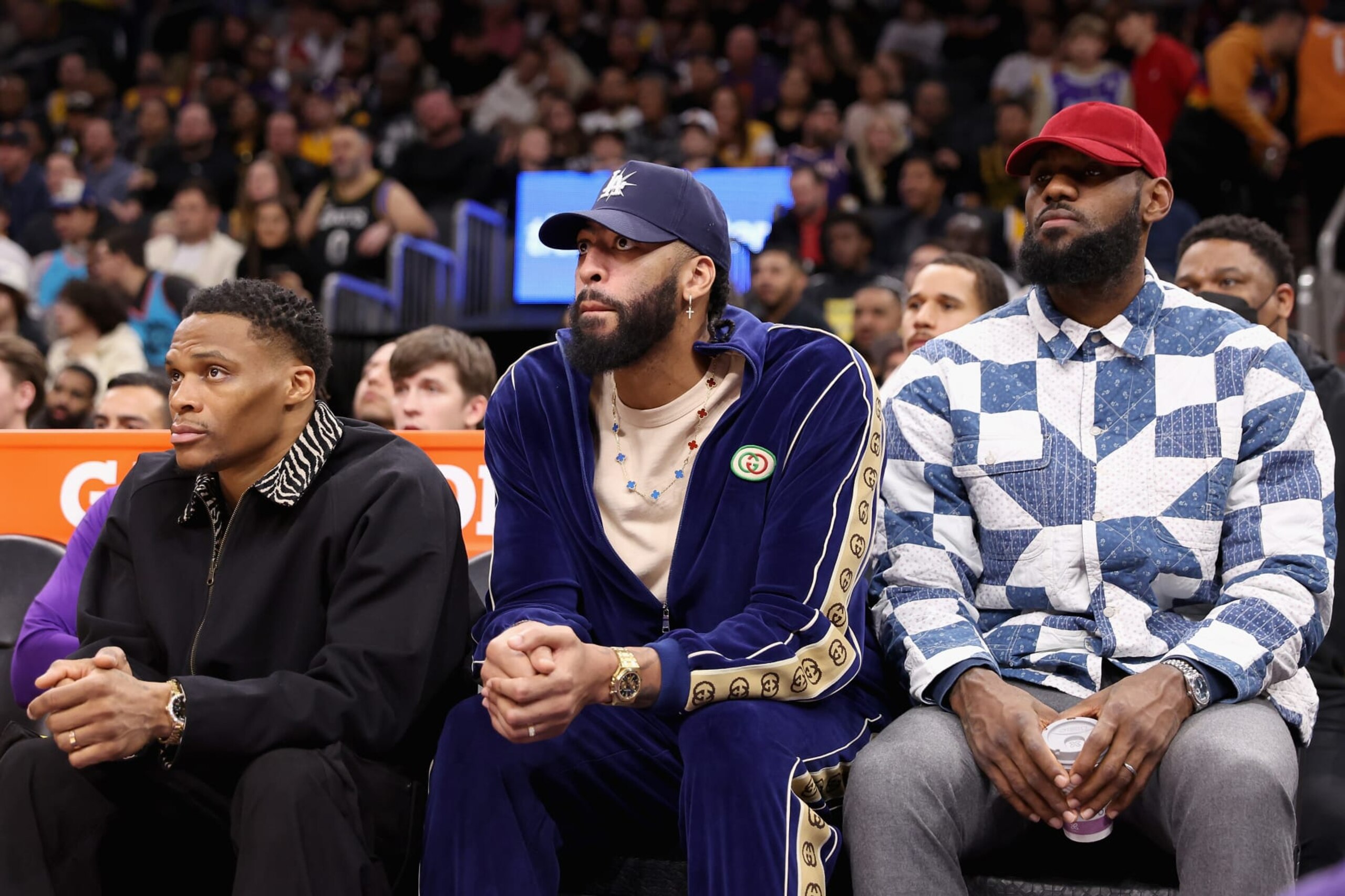 PHOENIX, ARIZONA - DECEMBER 19: (L-R) Russell Westbrook #0, Anthony Davis #3 and LeBron James #6 of the Los Angeles Lakers watch from the bench during the first half of the NBA game against the Phoenix Suns at Footprint Center on December 19, 2022 in Phoenix, Arizona. NOTE TO USER: User expressly acknowledges and agrees that, by downloading and or using this photograph, User is consenting to the terms and conditions of the Getty Images License Agreement. (Photo by Christian Petersen/Getty Images)