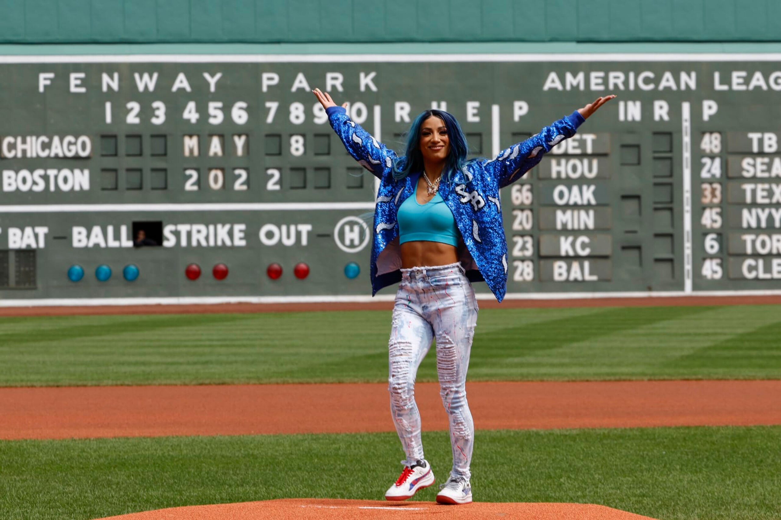 BOSTON, MA - MAY 8: Six time WWE Womens Champion Sasha Banks holds up her arms after throwing out the first pitch before the game between the Boston Red Sox and the Chicago White Sox at Fenway Park on May 8, 2022 in Boston, Massachusetts. (Photo By Winslow Townson/Getty Images)