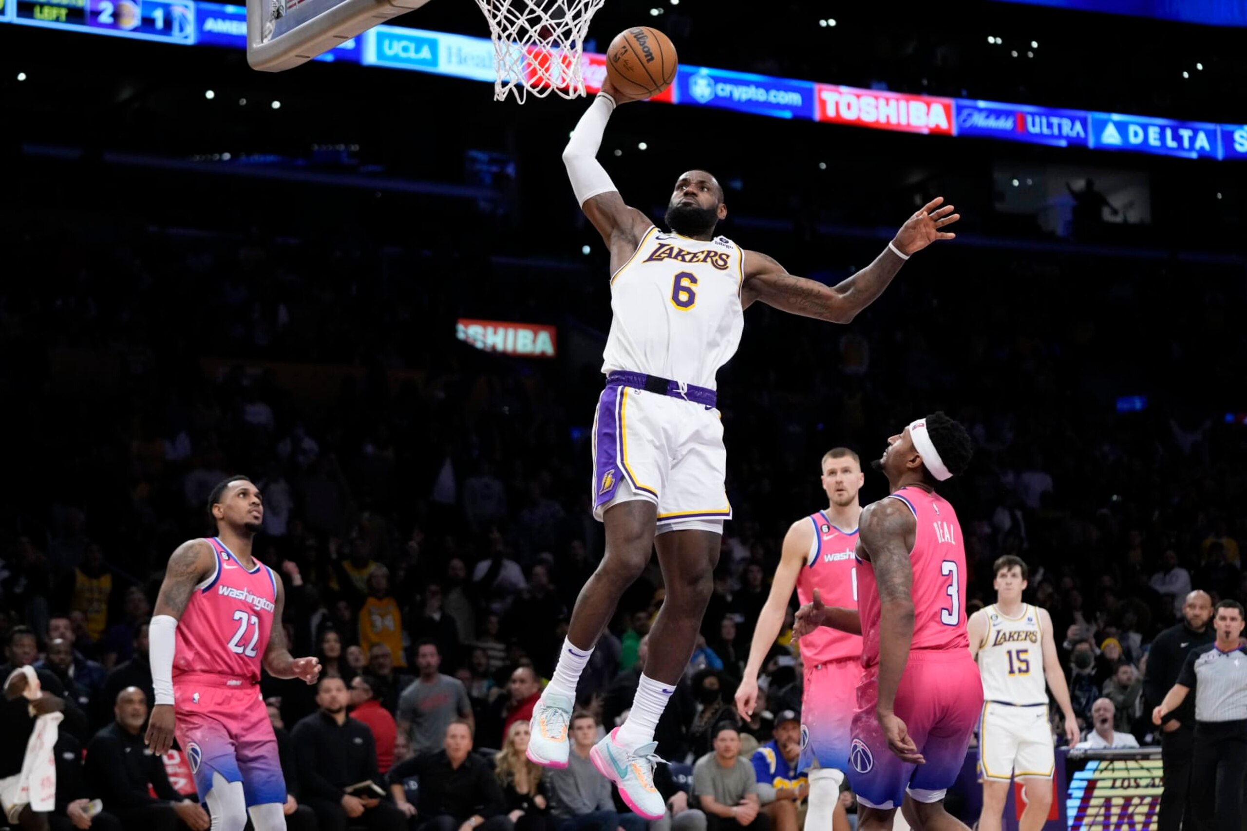 Los Angeles Lakers' LeBron James (6) goes up for a dunk as Washington Wizards' Bradley Beal (3), Monte Morris (22) watch during the second half of an NBA basketball game Sunday, Dec. 18, 2022, in Los Angeles. The Lakers won 119-117. (AP Photo/Jae C. Hong) Los Angeles Lakers' LeBron James (6) goes up for a dunk as Washington Wizards' Bradley Beal (3), Monte Morris (22) watch during the second half of an NBA basketball game Sunday, Dec. 18, 2022, in Los Angeles. The Lakers won 119-117. (AP Photo/Jae C. Hong)