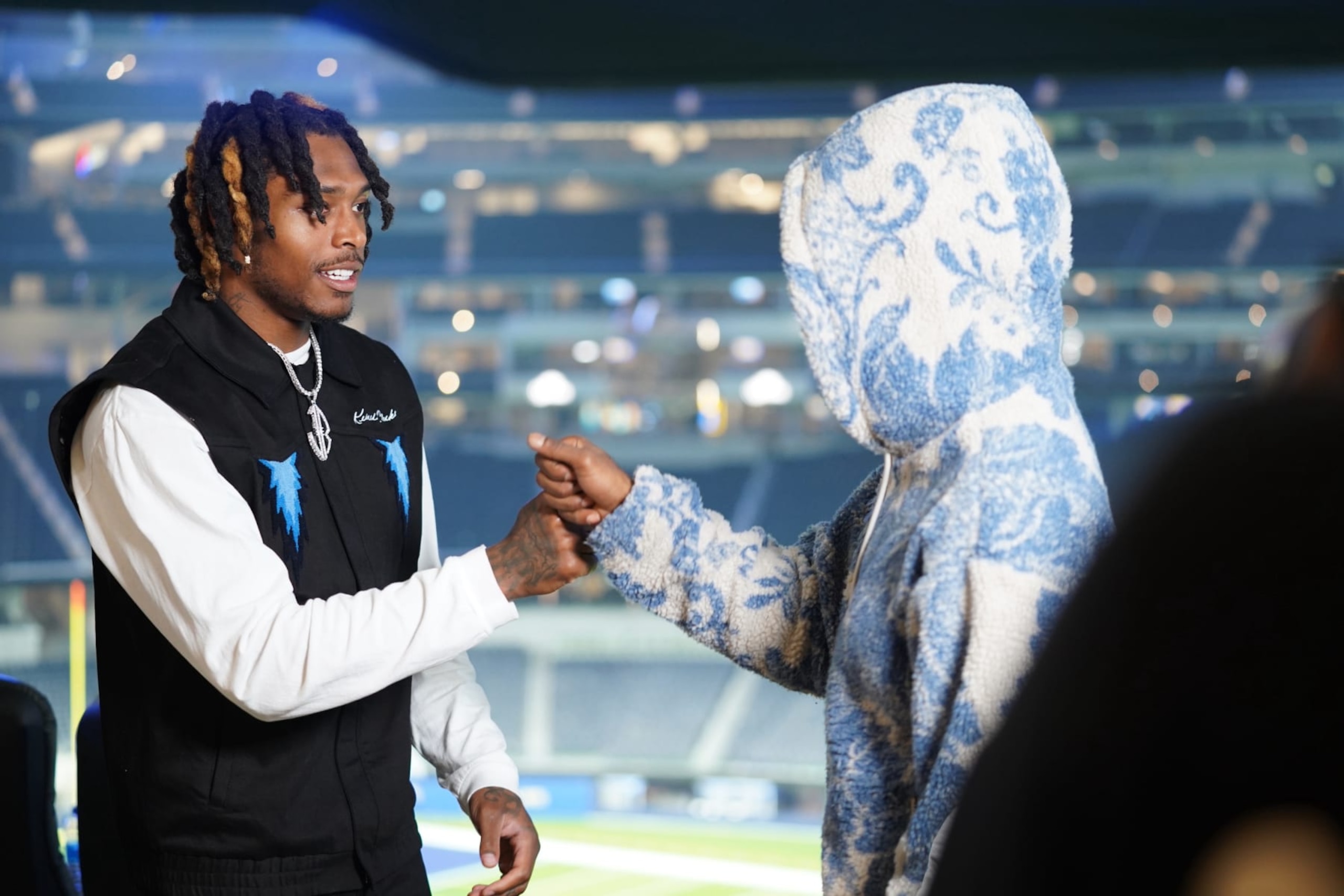 Ramsey greets the musician Famous Los for a guest spot on his show, which usually happens right after games.