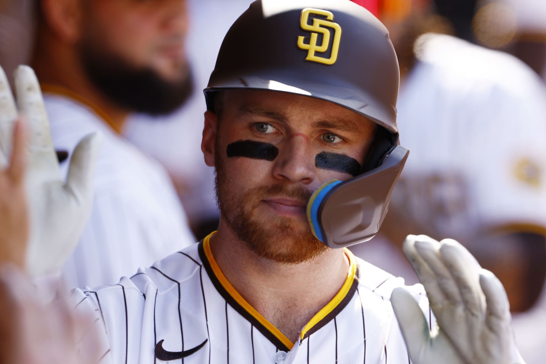 SAN DIEGO, CALIFORNIA - OCTOBER 19: Brandon Drury #17 of the San Diego Padres celebrates in the dugout after hitting a solo home run during the second inning against the Philadelphia Phillies in game two of the National League Championship Series at PETCO Park on October 19, 2022 in San Diego, California. (Photo by Ronald Martinez/Getty Images)