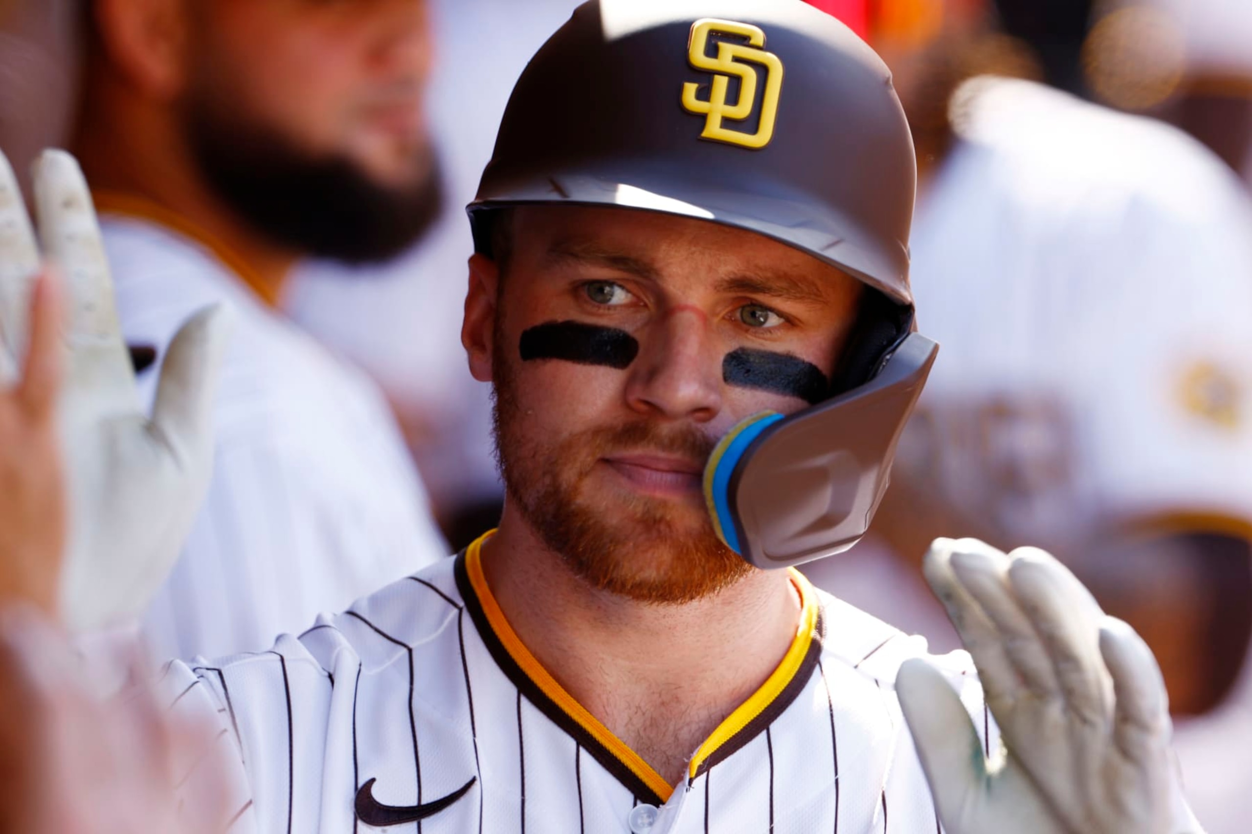 SAN DIEGO, CALIFORNIA - OCTOBER 19: Brandon Drury #17 of the San Diego Padres celebrates in the dugout after hitting a solo home run during the second inning against the Philadelphia Phillies in game two of the National League Championship Series at PETCO Park on October 19, 2022 in San Diego, California. (Photo by Ronald Martinez/Getty Images)