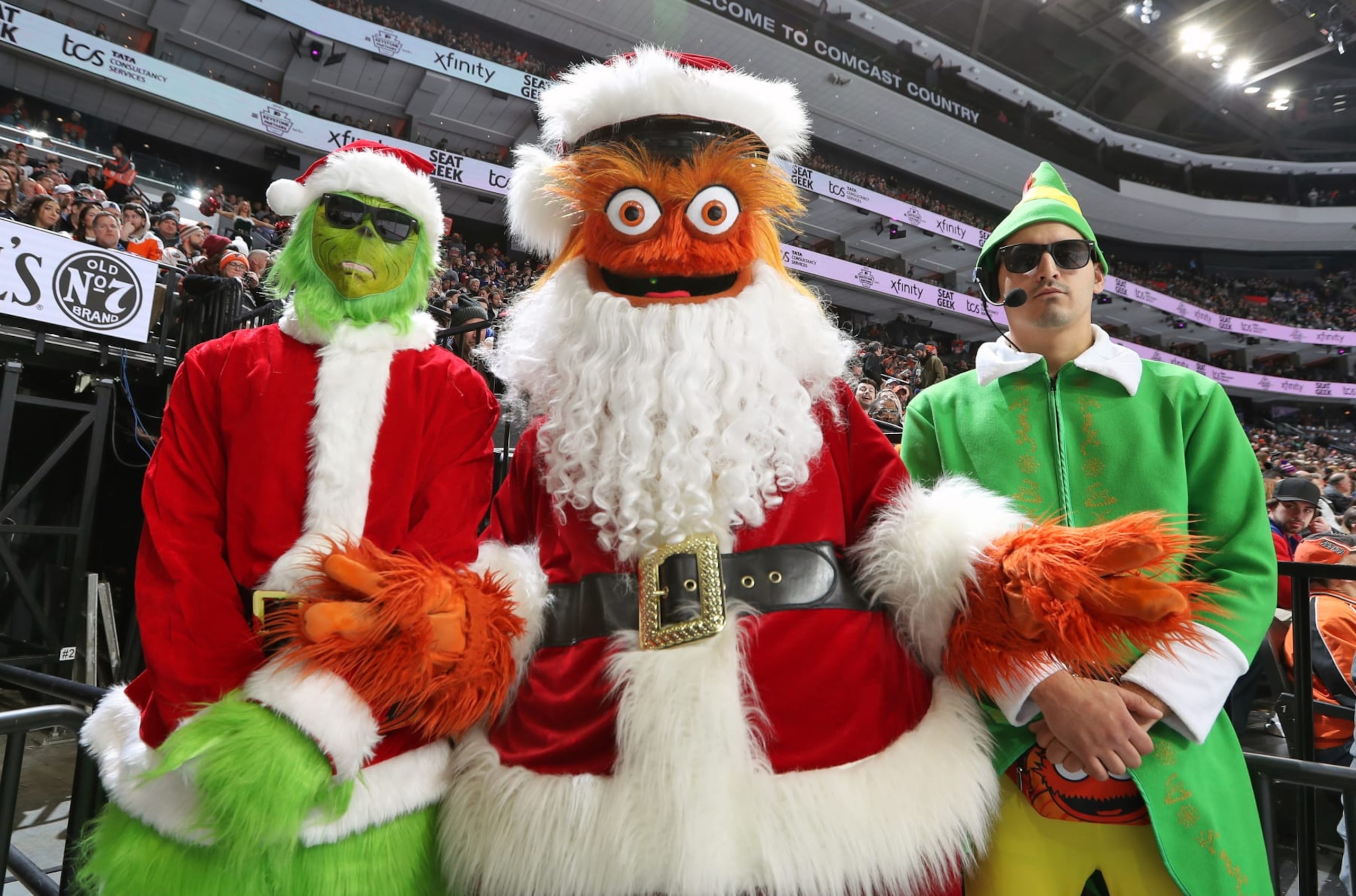 PHILADELPHIA, PENNSYLVANIA - DECEMBER 17:  Gritty the mascot of the Philadelphia Flyers dressed as Santa Clause with the Holiday Body Guards pose for a photo during an NHL game against the New York Rangers at the Wells Fargo Center on December 17, 2022 in Philadelphia, Pennsylvania.  (Photo by Len Redkoles/NHLI via Getty Images)