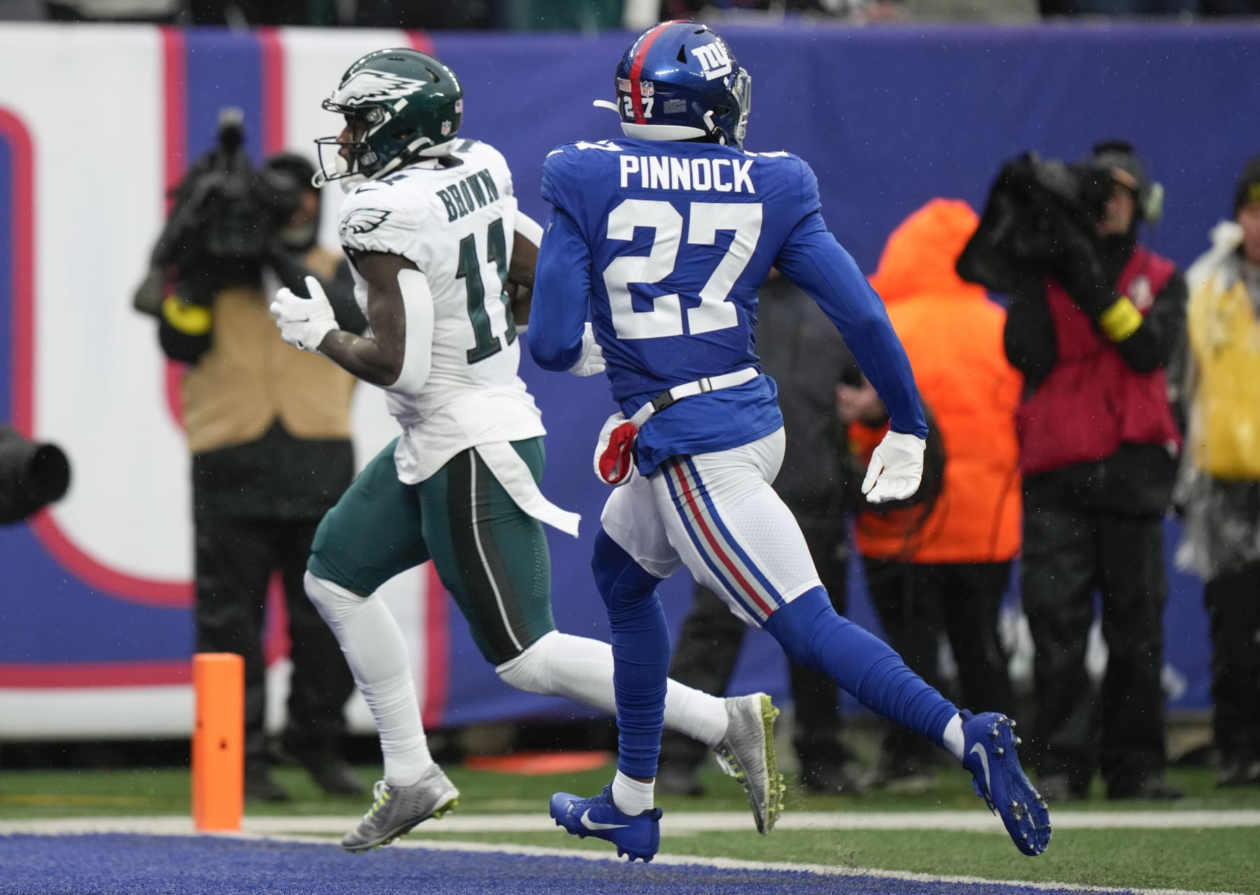 Philadelphia Eagles wide receiver A.J. Brown (11) crosses the goal line for at touchdown against New York Giants cornerback Jason Pinnock (27) during the second quarter of an NFL football game, Sunday, Dec. 11, 2022, in East Rutherford, N.J. (AP Photo/Bryan Woolston)