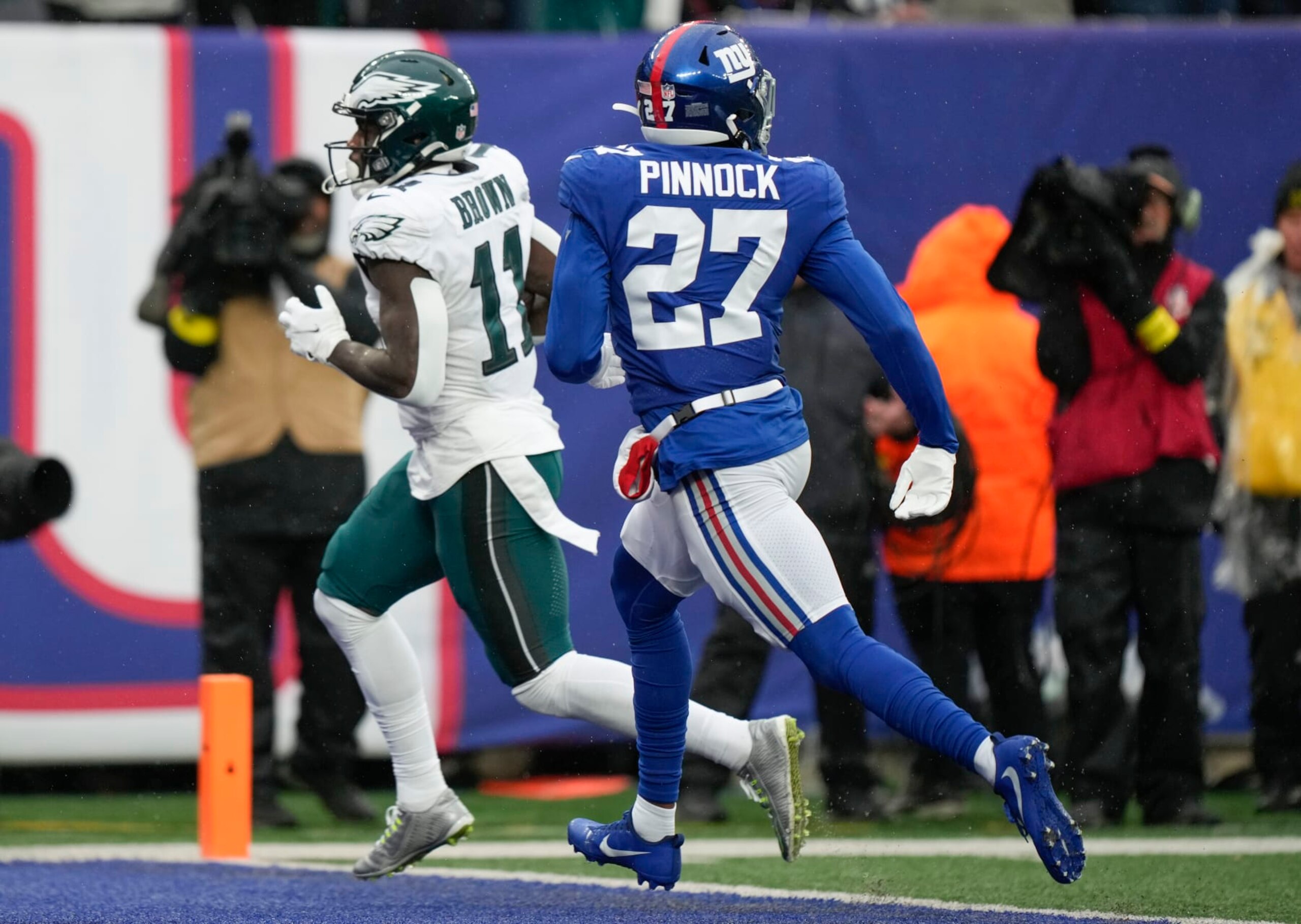 Philadelphia Eagles wide receiver A.J. Brown (11) crosses the goal line for at touchdown against New York Giants cornerback Jason Pinnock (27) during the second quarter of an NFL football game, Sunday, Dec. 11, 2022, in East Rutherford, N.J. (AP Photo/Bryan Woolston)