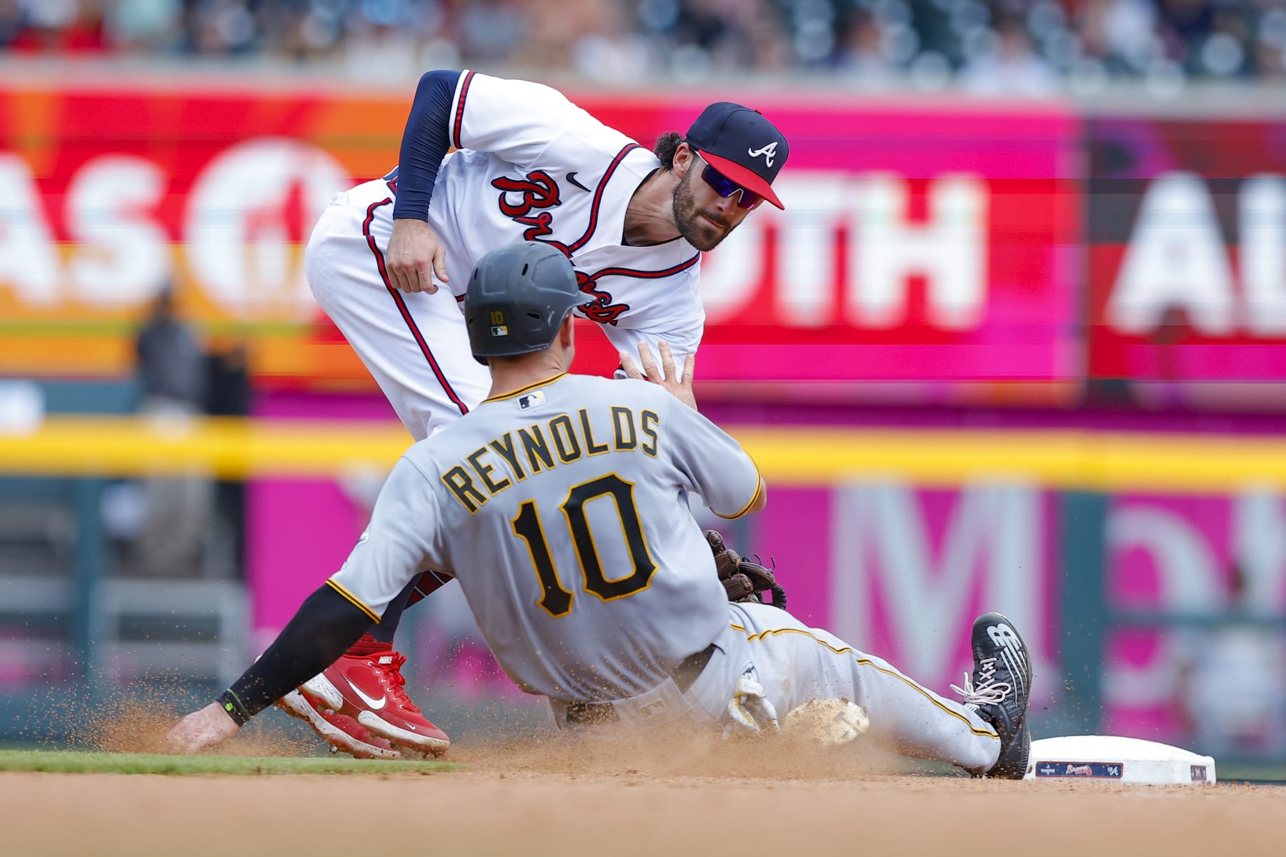 ATLANTA, GA - JUNE 12: Bryan Reynolds #10 of the Pittsburgh Pirates is out at second by Dansby Swanson #7 of the Atlanta Braves after a stolen base attempt during the eighth inning at Truist Park on June 12, 2022 in Atlanta, Georgia. (Photo by Todd Kirkland/Getty Images)