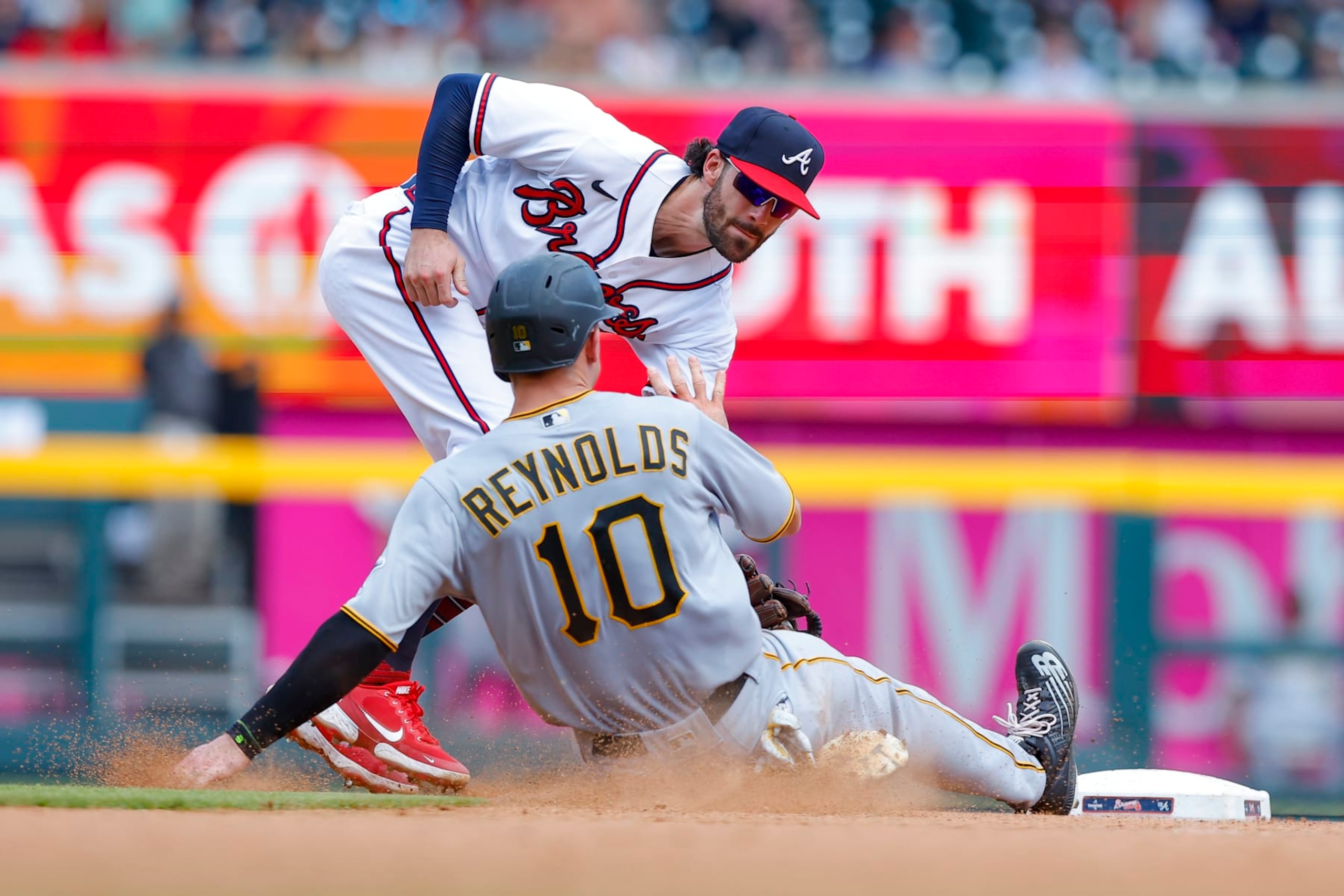 ATLANTA, GA - JUNE 12: Bryan Reynolds #10 of the Pittsburgh Pirates is out at second by Dansby Swanson #7 of the Atlanta Braves after a stolen base attempt during the eighth inning at Truist Park on June 12, 2022 in Atlanta, Georgia. (Photo by Todd Kirkland/Getty Images)