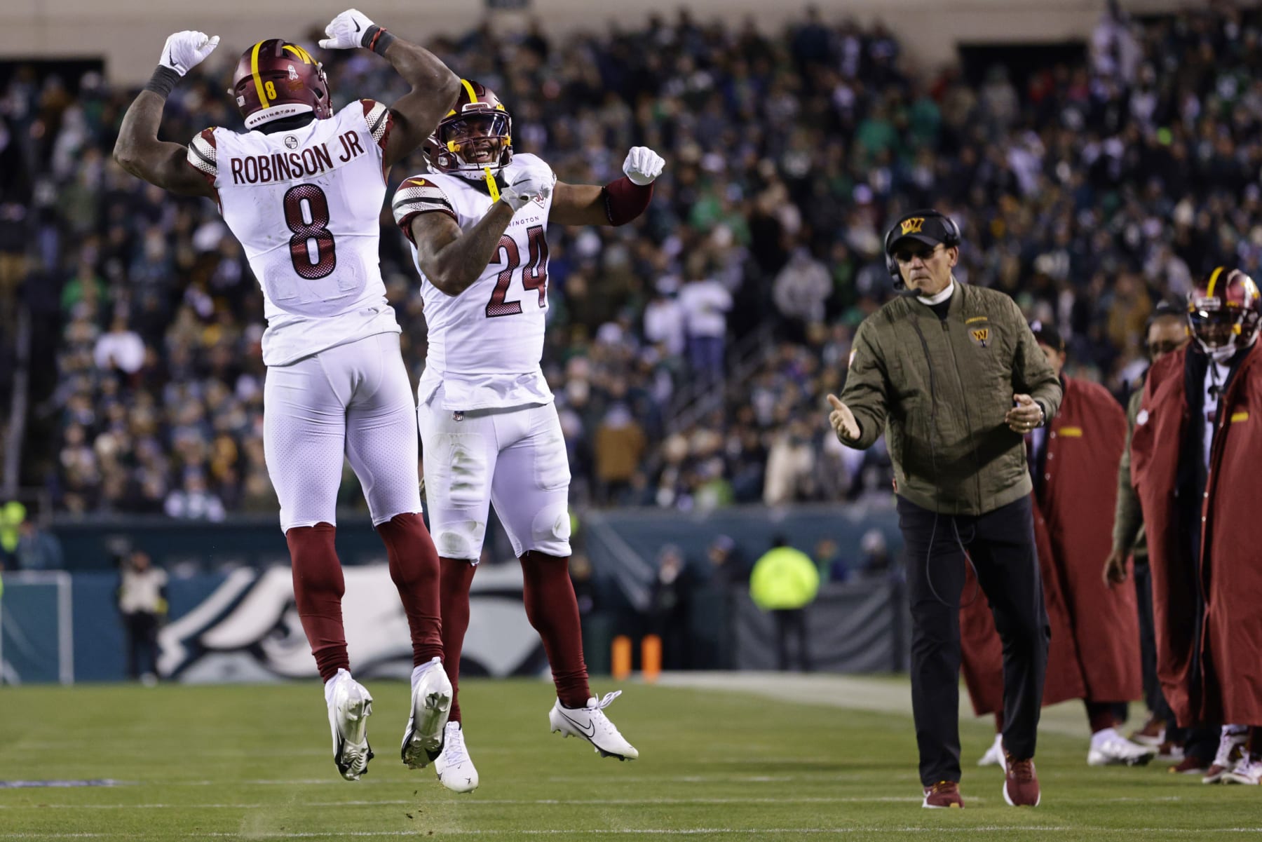 Washington Commanders running back Brian Robinson Jr. (8) celebrates his 1-yard touchdown run with Washington Commanders running back Antonio Gibson (24) during an NFL football game against the Philadelphia Eagles, Sunday, Nov. 14, 2022, in Philadelphia. The Commanders defeated the Eagles 32-21. (AP Photo/Rich Schultz)