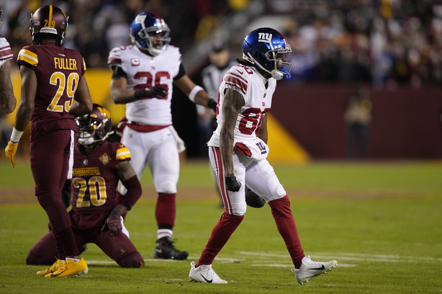 New York Giants wide receiver Richie James (80) celebrates after converting on a fourth down reception during the first half of an NFL football game against the Washington Commanders, Sunday, Dec. 18, 2022, in Landover, Md. (AP Photo/Susan Walsh)