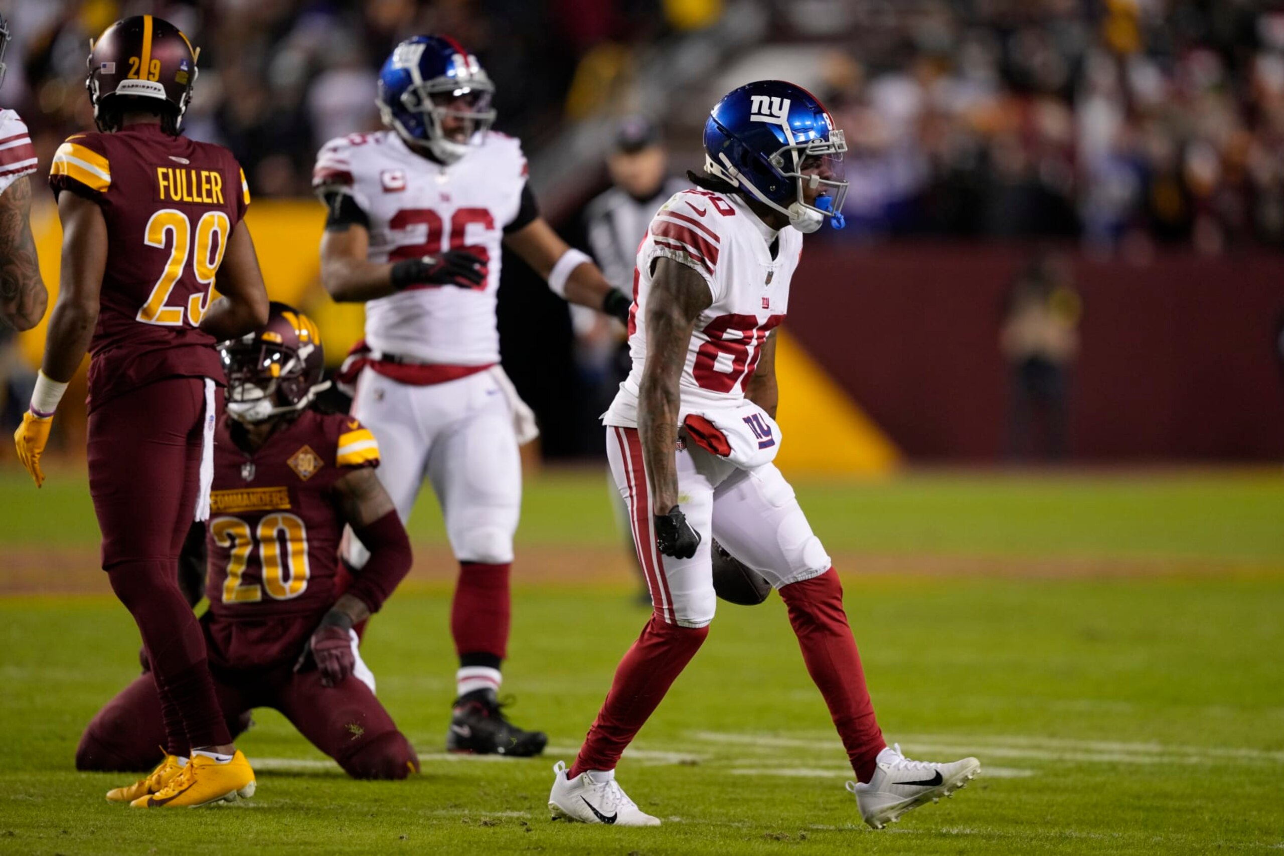 New York Giants wide receiver Richie James (80) celebrates after converting on a fourth down reception during the first half of an NFL football game against the Washington Commanders, Sunday, Dec. 18, 2022, in Landover, Md. (AP Photo/Susan Walsh)