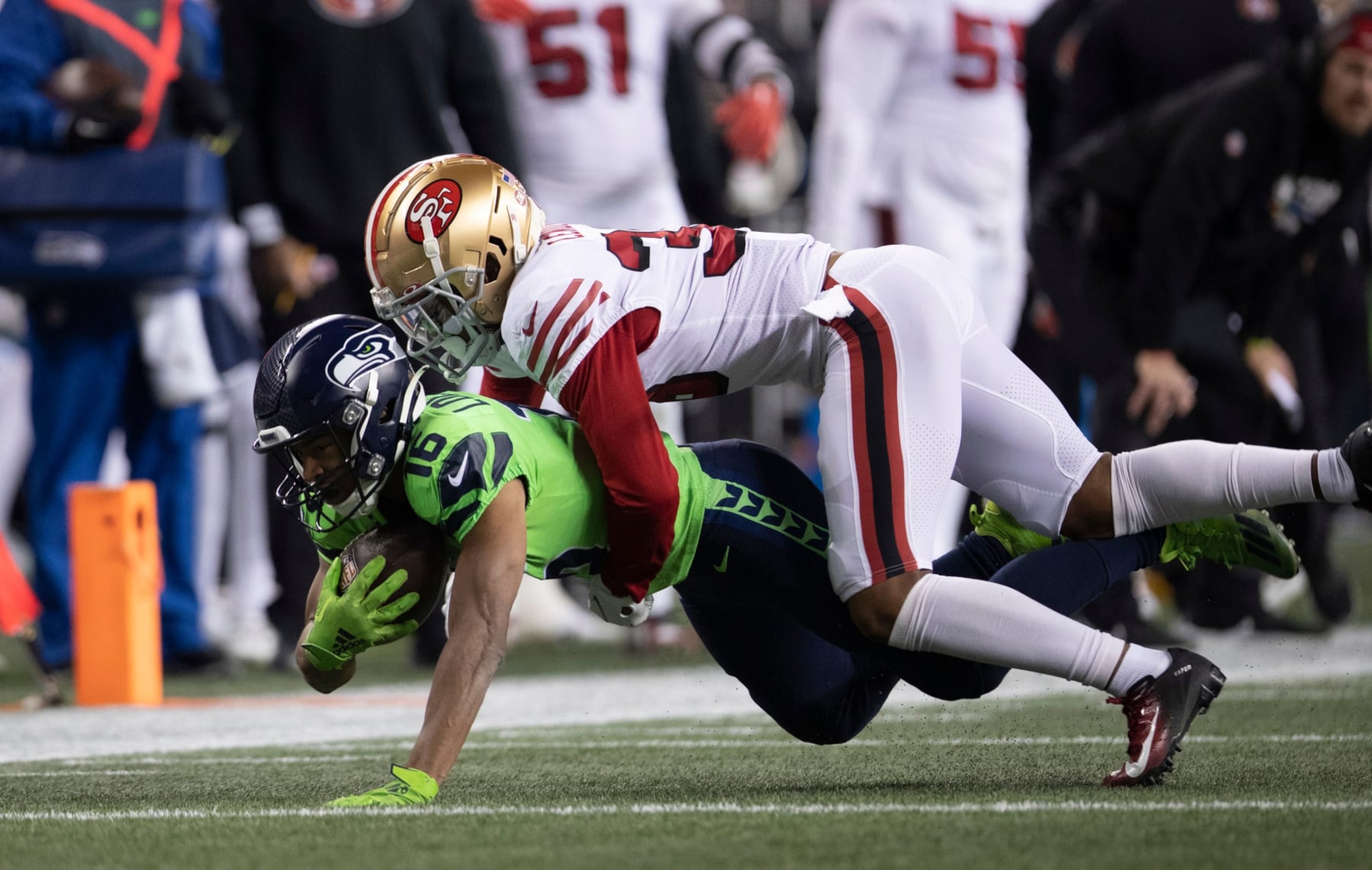 SEATTLE, WA - DECEMBER 15: Deommodore Lenoir #38 of the San Francisco 49ers tackles Tyler Lockett #16 of the Seattle Seahawks during the game at Lumen Field on December 15, 2022 in Seattle, Washington. The 49ers defeated the Seahawks 21-13. (Photo by Michael Zagaris/San Francisco 49ers/Getty Images)