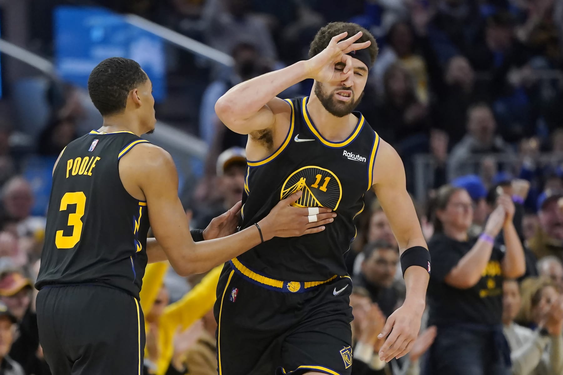 Golden State Warriors guard Klay Thompson, right, is congratulated by guard Jordan Poole (3) after making a 3-point basket against the Denver Nuggets during the first half of Game 1 of an NBA basketball first-round playoff series in San Francisco, Saturday, April 16, 2022. (AP Photo/Jeff Chiu)