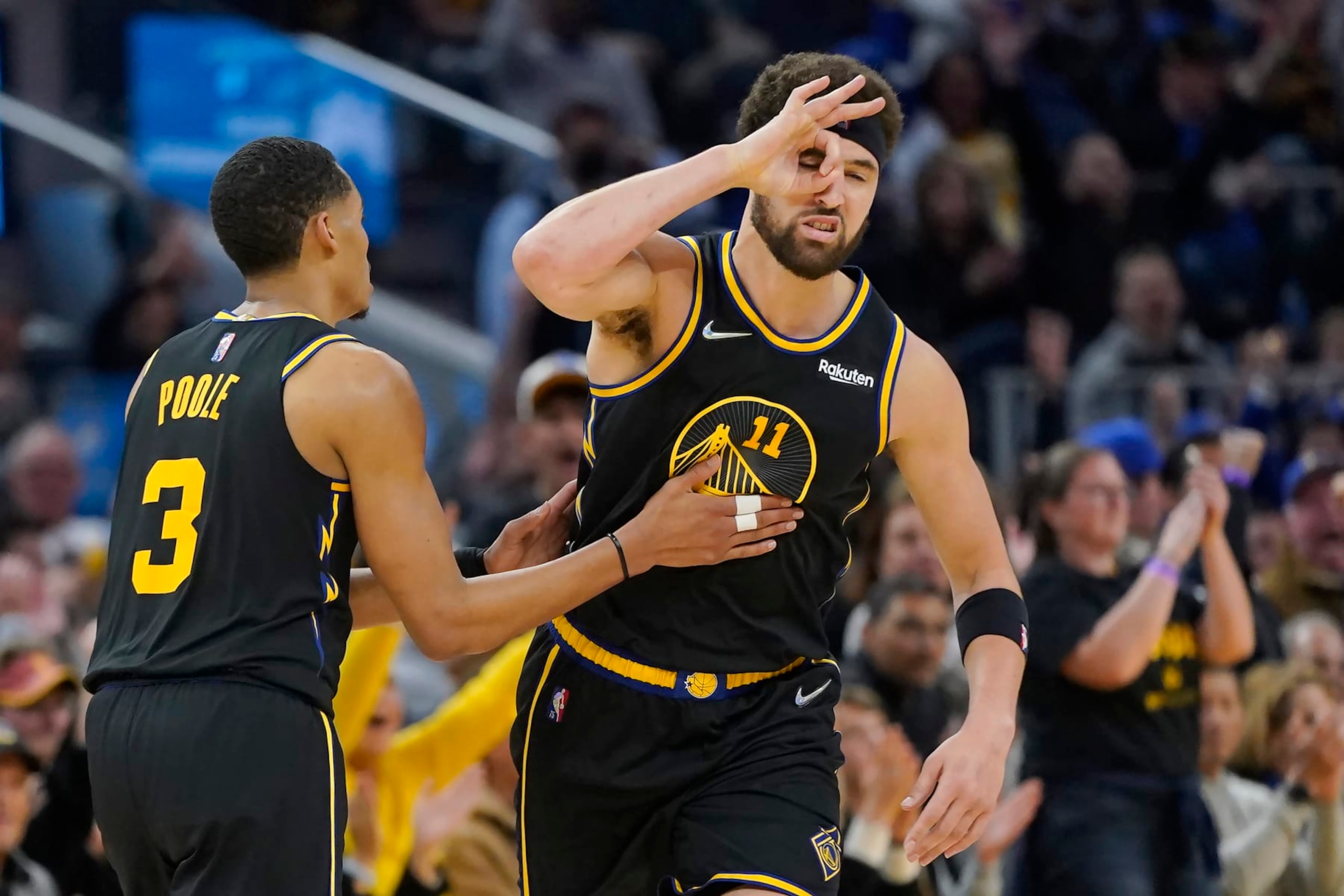 Golden State Warriors guard Klay Thompson, right, is congratulated by guard Jordan Poole (3) after making a 3-point basket against the Denver Nuggets during the first half of Game 1 of an NBA basketball first-round playoff series in San Francisco, Saturday, April 16, 2022. (AP Photo/Jeff Chiu)