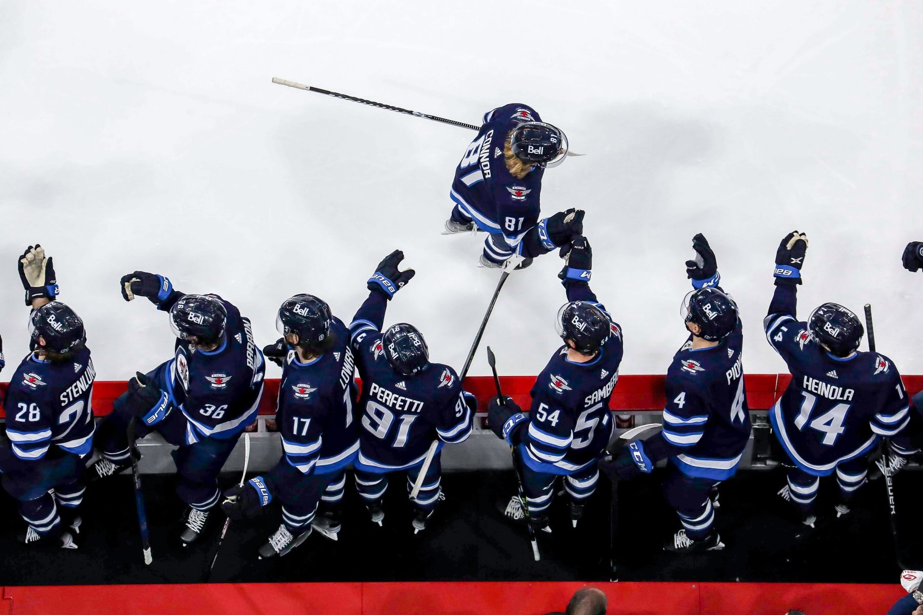 WINNIPEG, CANADA - DECEMBER 20: Kyle Connor #81 of the Winnipeg Jets celebrates his second period goal against the Ottawa Senators with teammates at the bench at the Canada Life Centre on December 20, 2022 in Winnipeg, Manitoba, Canada. (Photo by Darcy Finley/NHLI via Getty Images)