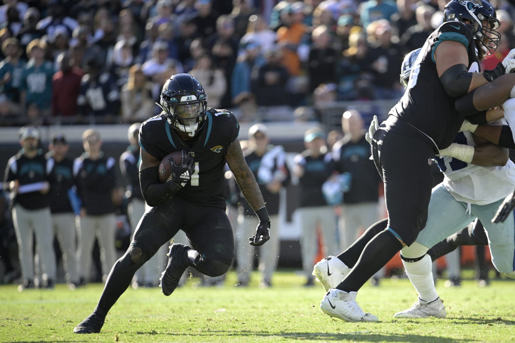 Jacksonville Jaguars running back Travis Etienne Jr. (1) rushes for yardage during the second half of an NFL football game against the Dallas Cowboys, Sunday, Dec. 18, 2022, in Jacksonville, Fla. (AP Photo/Phelan M. Ebenhack)