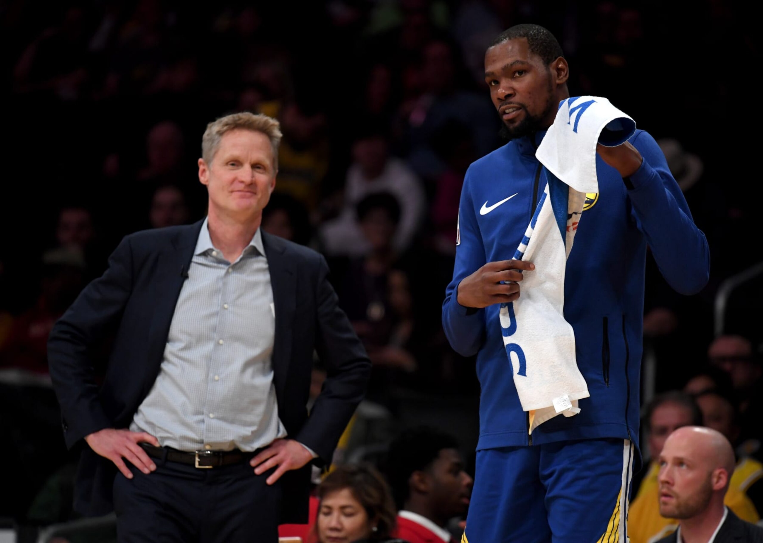 LOS ANGELES, CALIFORNIA - JANUARY 21:  Kevin Durant #35 and Steve Kerr of the Golden State Warriors smile courtside during a 130-111 win over the Los Angeles Lakers at Staples Center on January 21, 2019 in Los Angeles, California.  NOTE TO USER: User expressly acknowledges and agrees that, by downloading and or using this photograph, User is consenting to the terms and conditions of the Getty Images License Agreement. (Photo by Harry How/Getty Images)