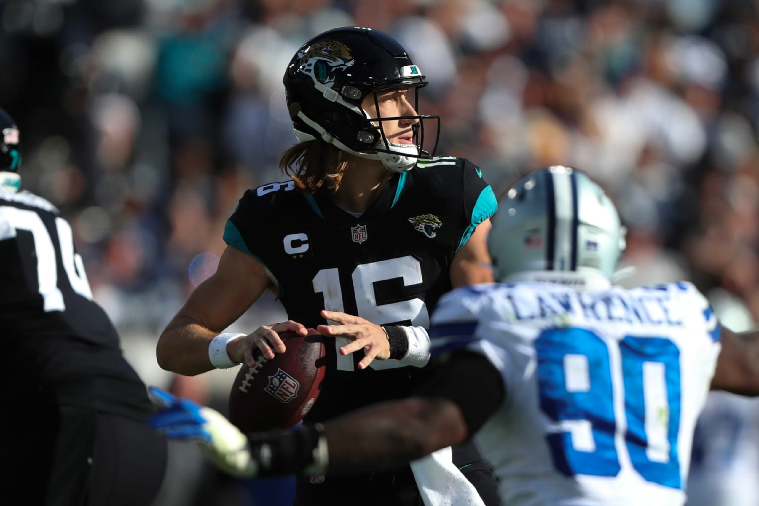 JACKSONVILLE, FLORIDA - DECEMBER 18: Trevor Lawrence #16 of the Jacksonville Jaguars throws a pass during the second half against the Dallas Cowboys at TIAA Bank Field on December 18, 2022 in Jacksonville, Florida. (Photo by Courtney Culbreath/Getty Images)