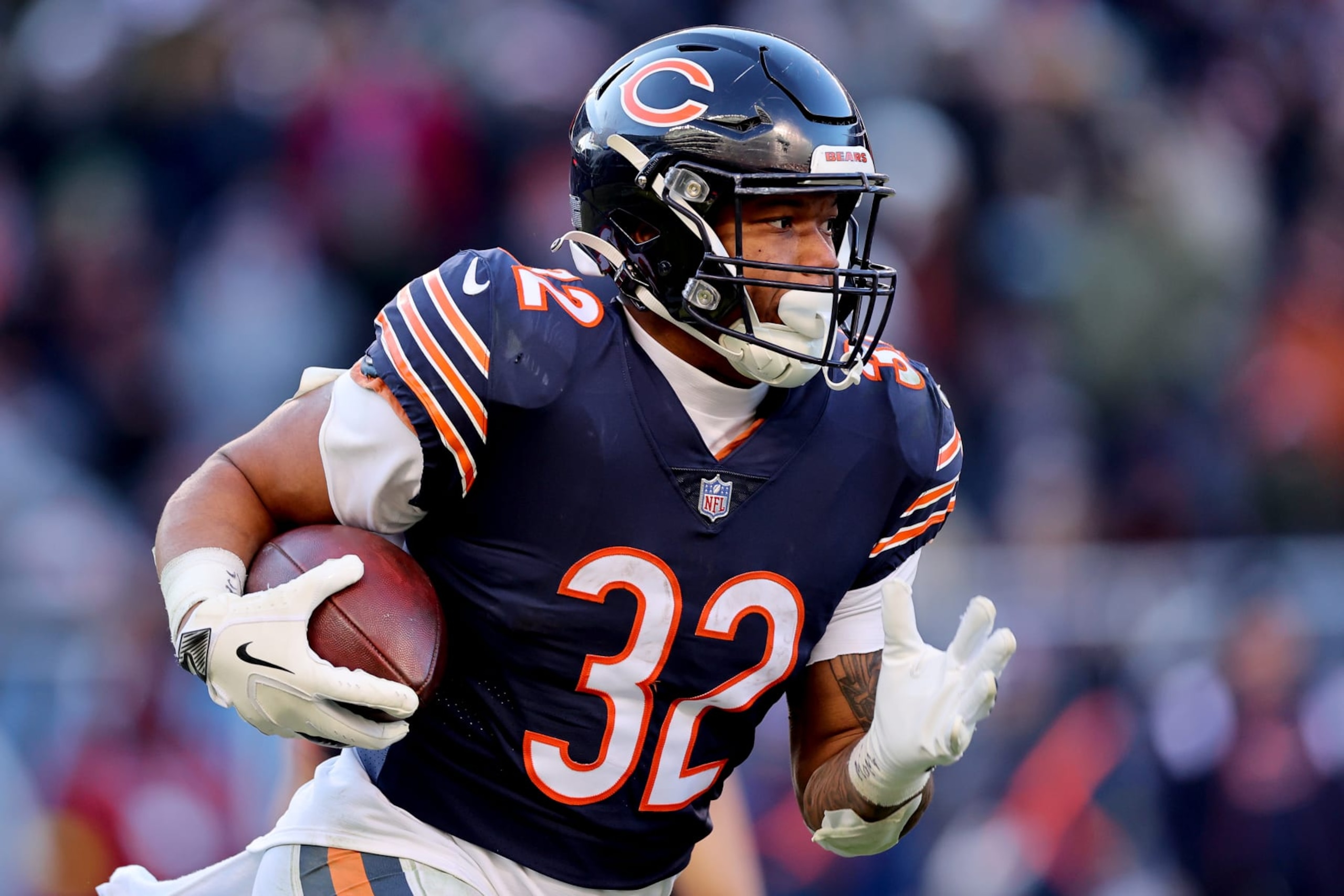 CHICAGO, ILLINOIS - DECEMBER 18: David Montgomery #32 of the Chicago Bears runs the ball during the second half in the game against the Philadelphia Eagles at Soldier Field on December 18, 2022 in Chicago, Illinois. (Photo by Michael Reaves/Getty Images)