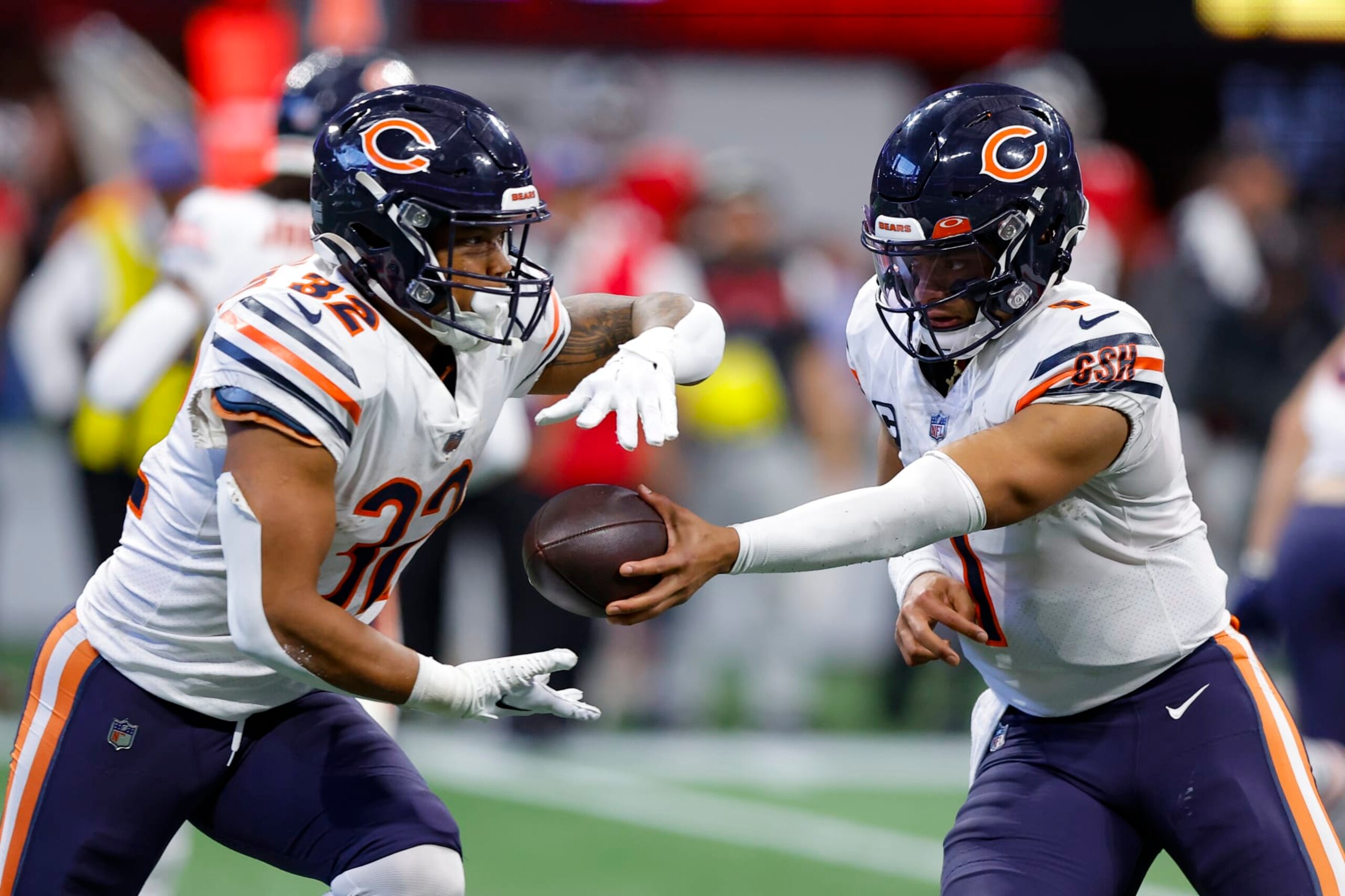 ATLANTA, GA - NOVEMBER 20: Justin Fields #1 of the Chicago Bears looks to hand off to David Montgomery #32 during the second half against the Atlanta Falcons at Mercedes-Benz Stadium on November 20, 2022 in Atlanta, Georgia. (Photo by Todd Kirkland/Getty Images)