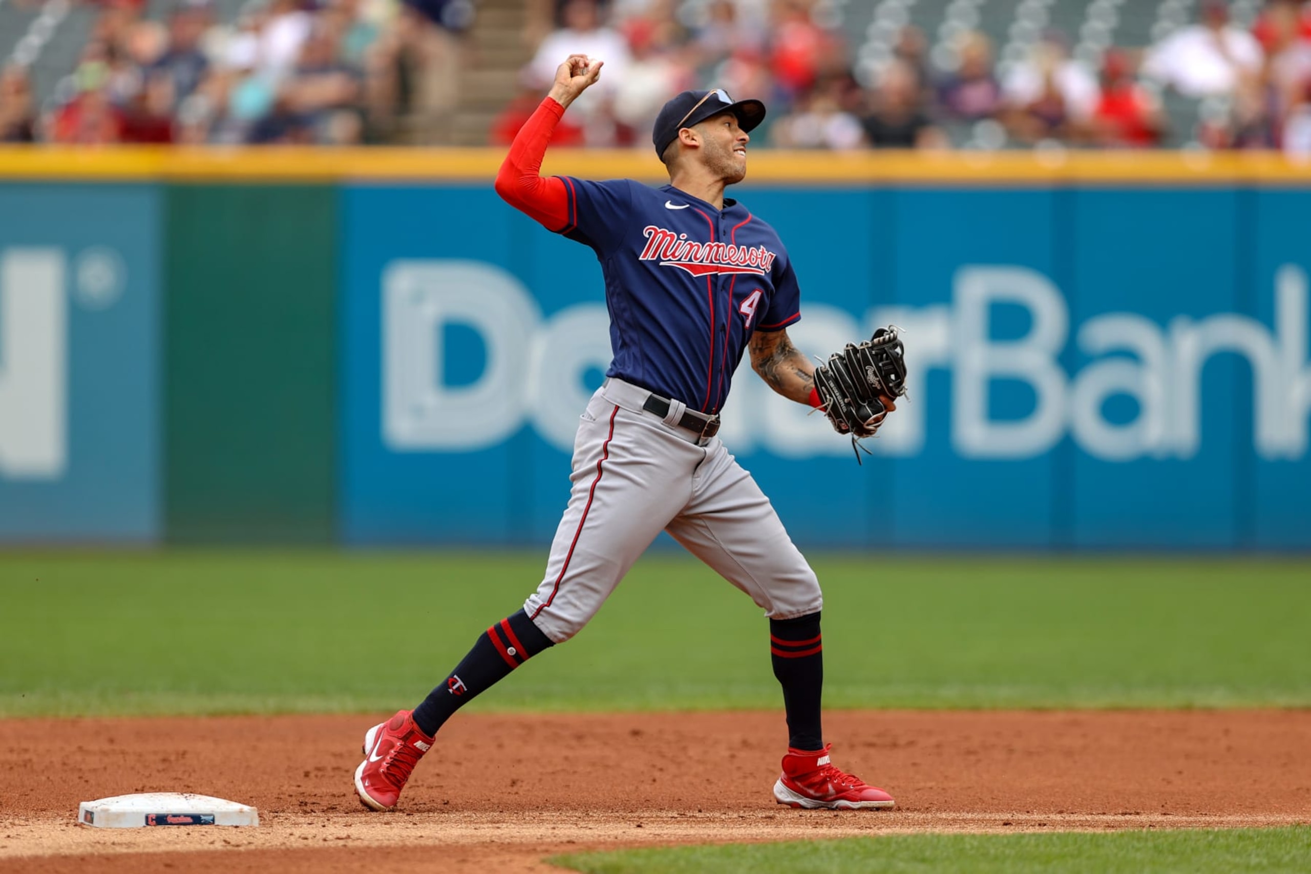 CLEVELAND, OH - SEPTEMBER 19: Minnesota Twins shortstop Carlos Correa (4) throws to first base to complete a double play during the first inning of the Major League Baseball game between the Minnesota Twins and Cleveland Guardians on September 19, 2022, at Progressive Field in Cleveland, OH. (Photo by Frank Jansky/Icon Sportswire via Getty Images)