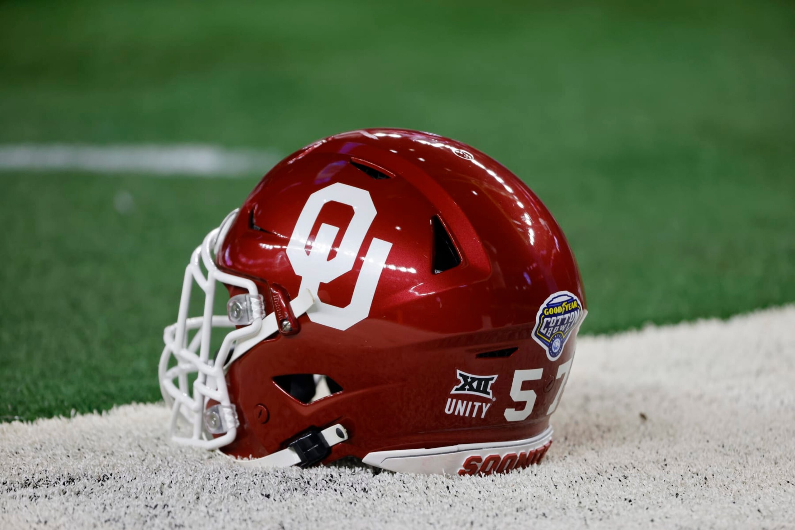 An Oklahoma helmet is shown on the field before their NCAA Cotton Bowl college football game against Florida in Arlington, Texas, Wednesday, Dec. 30, 2020. (AP Photo/Michael Ainsworth) An Oklahoma helmet is shown on the field before their NCAA Cotton Bowl college football game against Florida in Arlington, Texas, Wednesday, Dec. 30, 2020. (AP Photo/Michael Ainsworth)