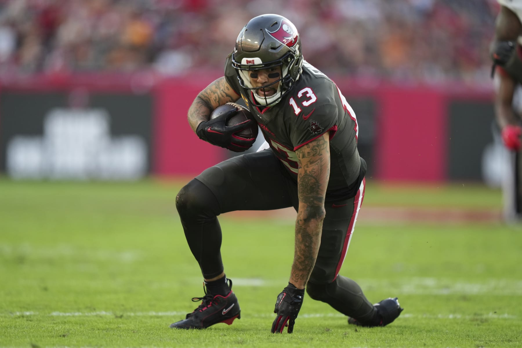 Tampa Bay Buccaneers wide receiver Mike Evans (13) gets up to run after making a diving reception during an NFL football game against the Cincinnati Bengals, Sunday, Dec. 18, 2022, in Tampa, Fla. (AP Photo/Peter Joneleit)