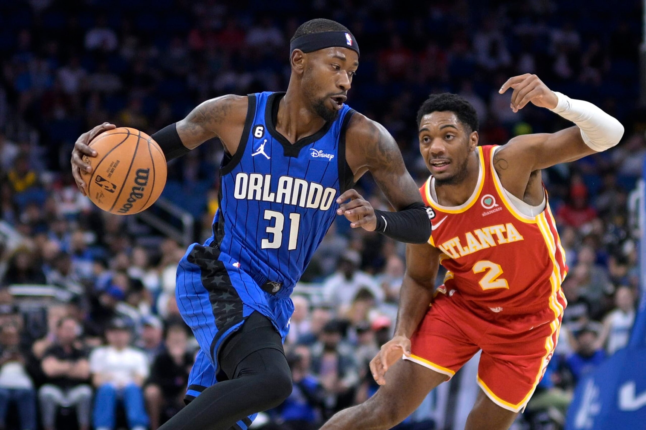 Orlando Magic guard Terrence Ross (31) drives to the basket while defended by Atlanta Hawks guard Trent Forrest (2) during the first half of an NBA basketball game Wednesday, Nov. 30, 2022, in Orlando, Fla. (AP Photo/Phelan M. Ebenhack)