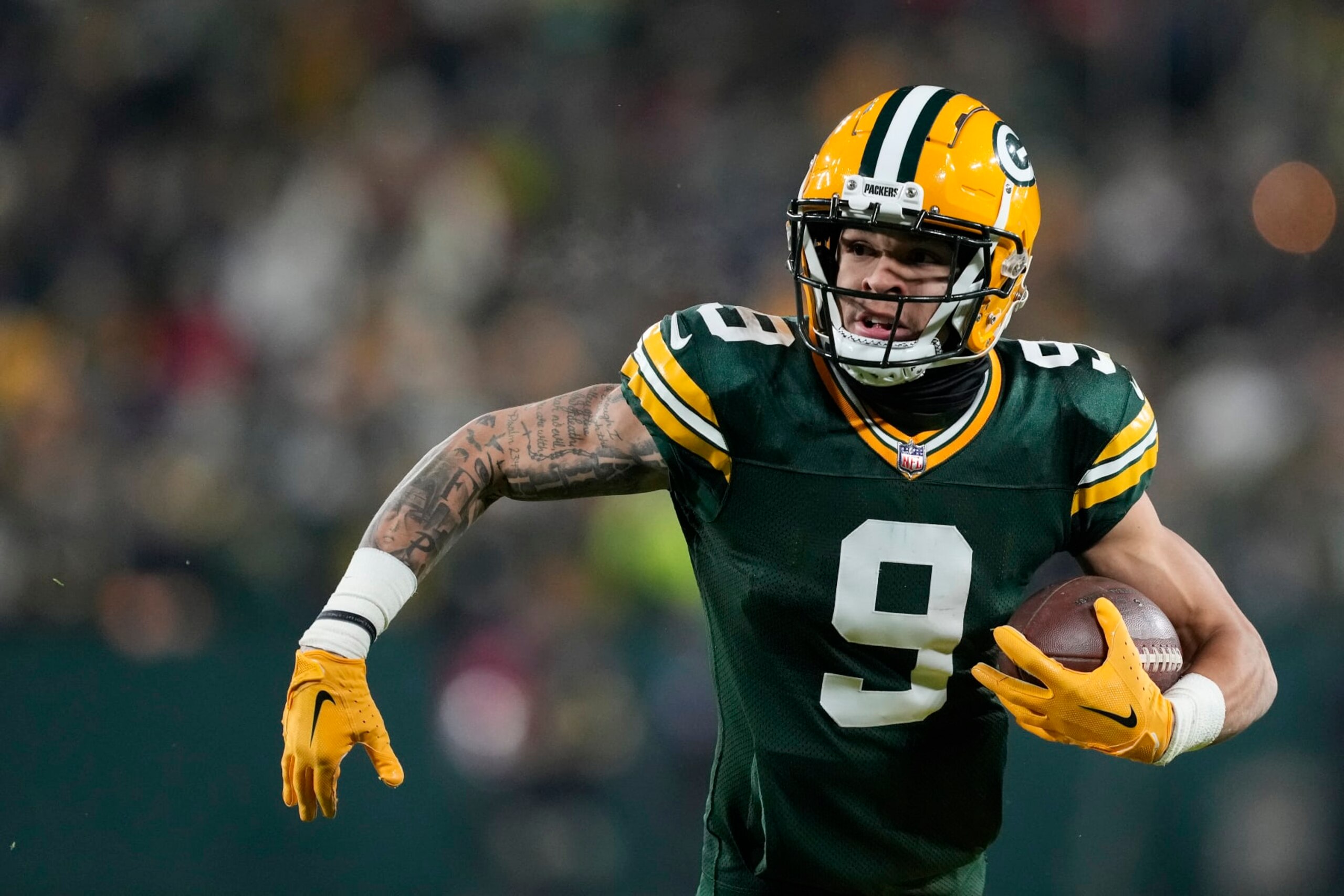 GREEN BAY, WISCONSIN - DECEMBER 19: Christian Watson #9 of the Green Bay Packers runs with the ball against the Los Angeles Rams in the second half at Lambeau Field on December 19, 2022 in Green Bay, Wisconsin. (Photo by Patrick McDermott/Getty Images)