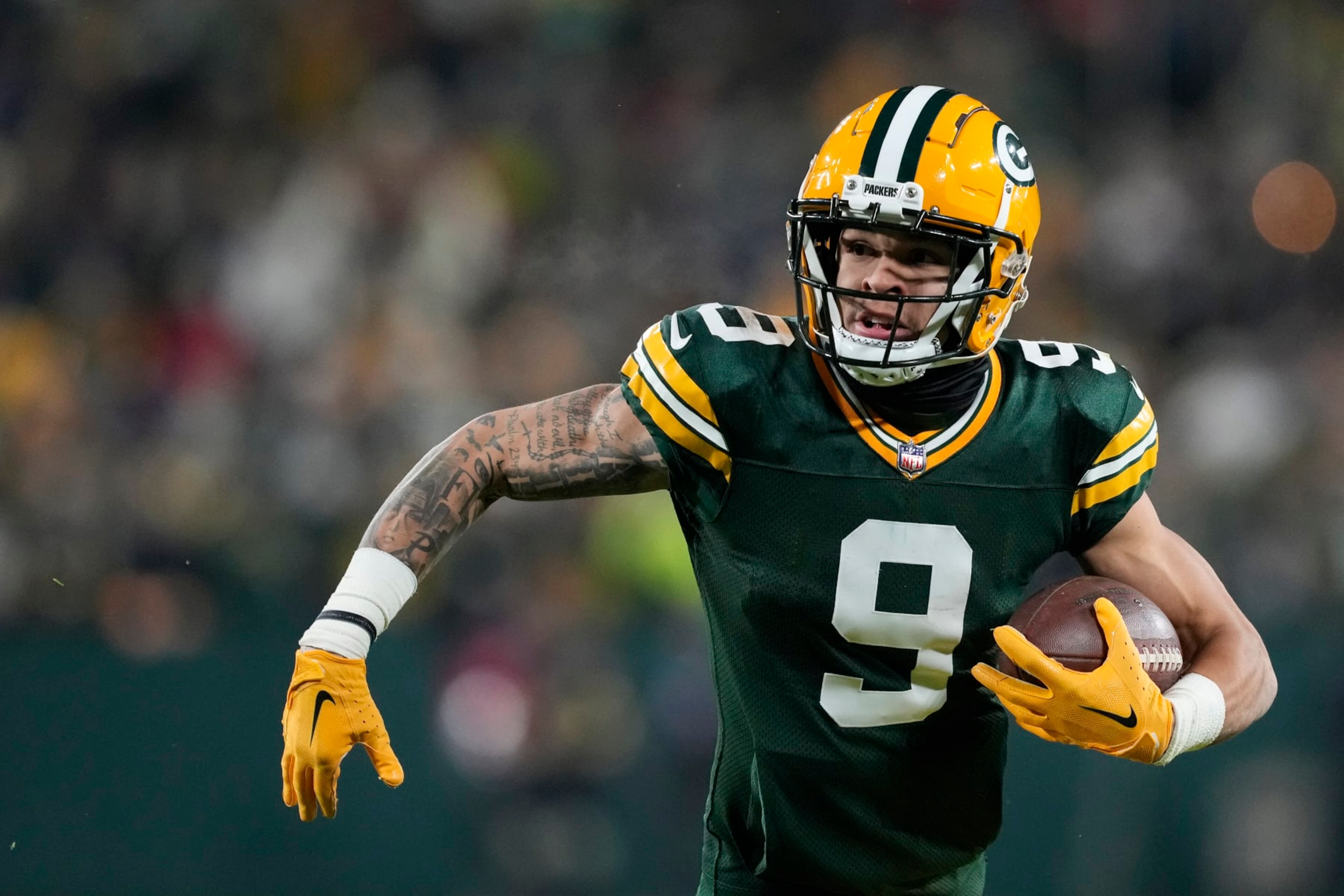 GREEN BAY, WISCONSIN - DECEMBER 19: Christian Watson #9 of the Green Bay Packers runs with the ball against the Los Angeles Rams in the second half at Lambeau Field on December 19, 2022 in Green Bay, Wisconsin. (Photo by Patrick McDermott/Getty Images)