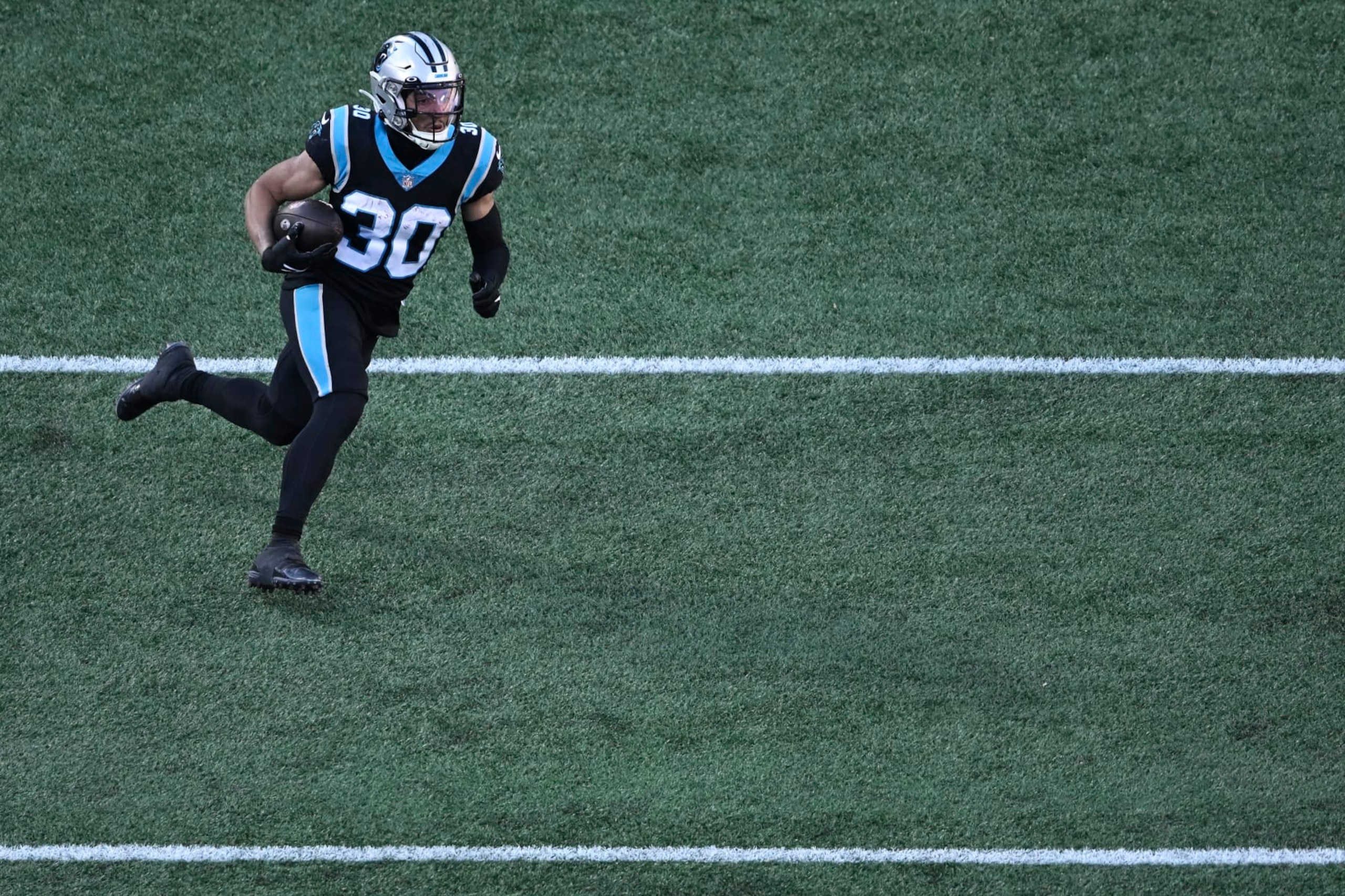 CHARLOTTE, NORTH CAROLINA - DECEMBER 18: Chuba Hubbard #30 of the Carolina Panthers runs the ball against the Pittsburgh Steelers in the third quarter at Bank of America Stadium on December 18, 2022 in Charlotte, North Carolina. (Photo by Eakin Howard/Getty Images)
