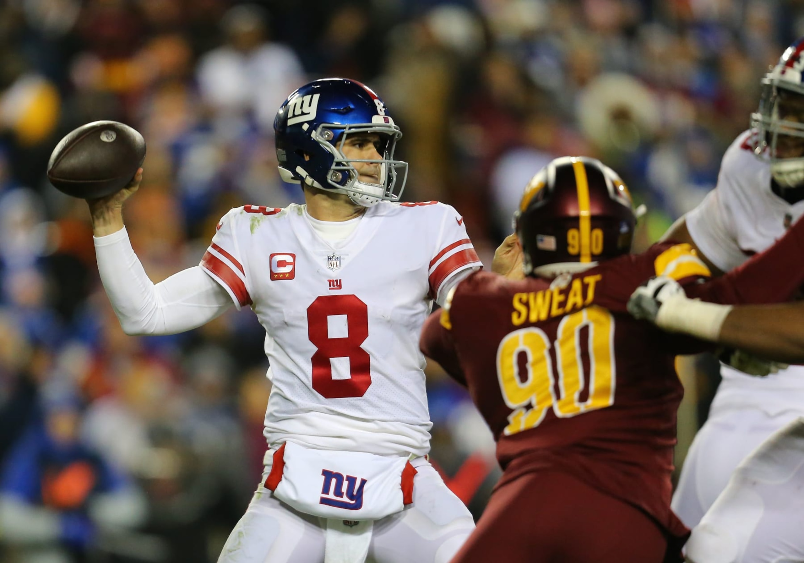 LANDOVER, MD - DECEMBER 18: New York Giants quarterback Daniel Jones (8) throws a pass from the pocket while being pressured by Washington Commanders defensive end Montez Sweat (90) during the New York Giants game versus the Washington Commanders on December 18, 2022, at FedEx Field in Landover, MD. (Photo by Lee Coleman/Icon Sportswire via Getty Images)