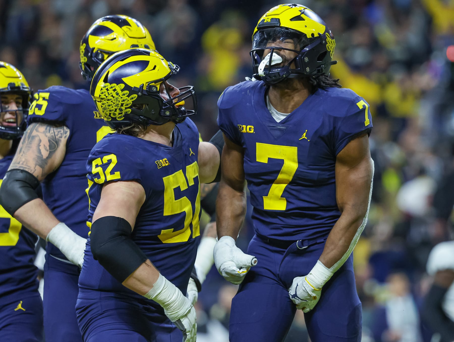 INDIANAPOLIS, IN - DECEMBER 04: Members of the Michigan Wolverines celebrate with Donovan Edwards #7 of the Michigan Wolverines after a touchdown during the second half of the Big Ten Championship against the Purdue Boilermakers at Lucas Oil Stadium on December 3, 2022 in Indianapolis, Indiana. (Photo by Michael Hickey/Getty Images)