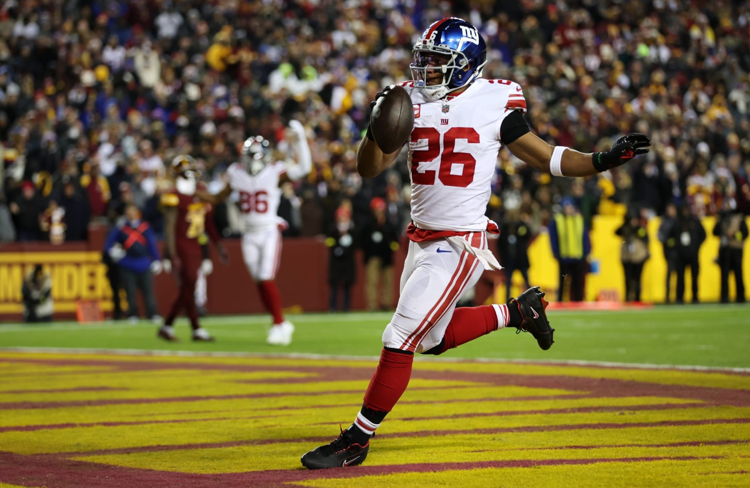 LANDOVER, MARYLAND - DECEMBER 18: Saquon Barkley #26 of the New York Giants scores a touchdown during the second quarter against the Washington Commanders at FedExField on December 18, 2022 in Landover, Maryland. (Photo by Rob Carr/Getty Images) LANDOVER, MARYLAND - DECEMBER 18: Saquon Barkley #26 of the New York Giants scores a touchdown during the second quarter against the Washington Commanders at FedExField on December 18, 2022 in Landover, Maryland. (Photo by Rob Carr/Getty Images)