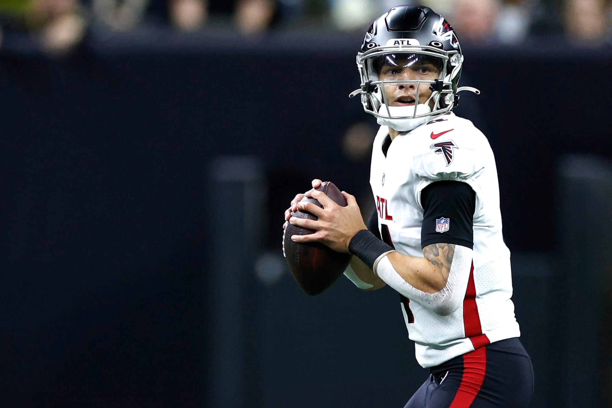 NEW ORLEANS, LOUISIANA - DECEMBER 18: Desmond Ridder #4 of the Atlanta Falcons looks to pass during the first half in the game against the New Orleans Saints at Caesars Superdome on December 18, 2022 in New Orleans, Louisiana. (Photo by Chris Graythen/Getty Images) NEW ORLEANS, LOUISIANA - DECEMBER 18: Desmond Ridder #4 of the Atlanta Falcons looks to pass during the first half in the game against the New Orleans Saints at Caesars Superdome on December 18, 2022 in New Orleans, Louisiana. (Photo by Chris Graythen/Getty Images)